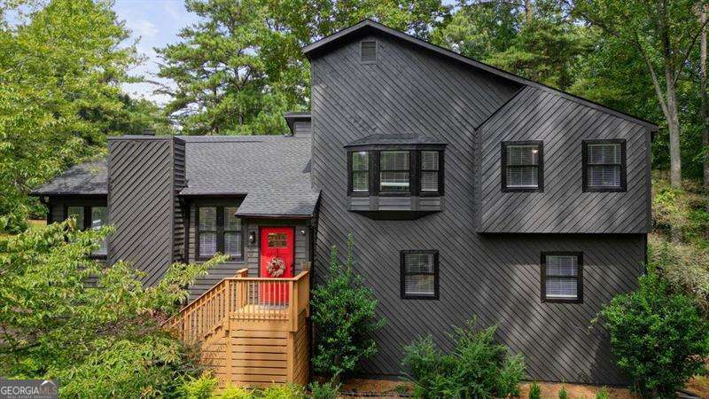Welcome to this beautifully renovated 5BR/3BA contemporary home in the sought-after Lassiter High School District! This stunning updated home has been renovated inside and out. Step into the front entryway and be welcomed by soaring vaulted ceilings, an abundance of natural light, and an open-concept living space that creates a seamless flow throughout. Enjoy fresh interior and exterior paint, luxury vinyl plank flooring in the main living areas, primary suite, and downstairs bedroom, with plush carpeting in the secondary bedrooms. The open-concept living area features a stunning stone fireplace and a fully renovated kitchen with quartz counter tops, stainless steel appliances, a coffee bar, additional storage, and a drink fridge for added convenience. The bright and airy dining area opens to sliding glass doors leading to a newly stained deck-perfect for entertaining or enjoying a peaceful evening outdoors. Upstairs, you'll find a fully renovated guest bathroom, two spacious guest bedrooms, and a large primary suite. The primary suite includes a luxurious en suite bathroom with a large walk-in shower, custom wood wall treatment, double vanities, and a walk-in closet with custom built-ins. On the lower level, there's a second family room, two additional bedrooms, and a beautifully updated Jack and Jill bathroom-ideal for modern living. The laundry room on this level offers extra storage with built-in shelving and access to additional crawl space storage. Situated on a large corner lot, this home features a fenced-in backyard with mature trees for tranquility. Additional updates include a brand-new roof (2025), new HVAC system (2024), and a new water heater (2024). HOA for this community is an Optional Voluntary Association.