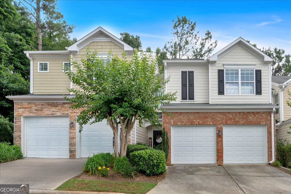 Bright, stylish, and move-in ready, this updated townhome combines modern finishes with everyday functionality in a peaceful, well-kept community. The recently renovated kitchen features granite countertops, stainless steel appliances, upgraded lighting, and a contemporary breakfast bar that opens to the fireside living room, perfect for gathering or relaxing at home. Thoughtfully designed, the main level features luxury vinyl plank flooring that adds both warmth and durability, while large windows invite in an abundance of natural light. Step outside to a private patio that backs up to quiet green space, offering a rare sense of privacy and calm. Upstairs, the oversized primary suite includes a vaulted ceiling, sitting area, spacious walk-in closet, and en-suite bath. Two additional bedrooms also feature walk-in closets and share convenient access to the upstairs laundry. The spacious two-car garage adds ease to daily life, and the community pool is just a short walk away. Ideally located minutes from shopping, dining, I-575 and I-75, and zoned for top-rated East Cobb schools, this home checks all the boxes for comfort, style, and location.