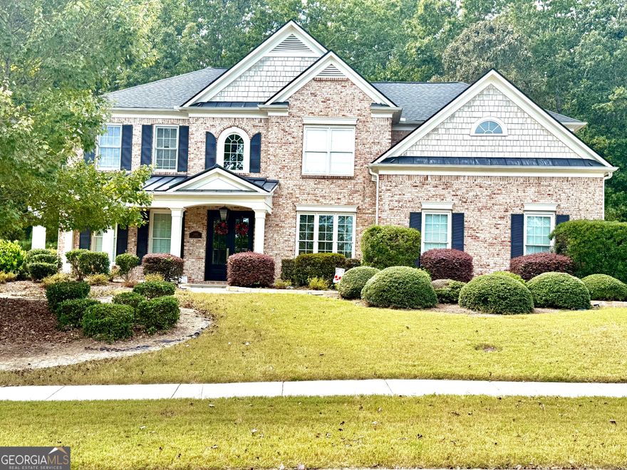 A dream home in the prestigious, private gated community of Walden Park this beautifully Designed 5 bdrm. 4 bath residence offers luxury, comfort and convenience-perfect for families and entertainers alike. Grand 2 story entrance foyer with abundant natural light, Expansive 2-story family room with floor to ceiling windows views of private backyard. Elegant hardwood floors throughout main level & guest bedroom. Chef-inspired kitchen featuring an oversized island, upgraded tile and backsplash, modern finishes. Stack stone fireplace in the family room for relaxing evenings. Spacious Owner's suite with trey ceilings, double French door entry, and a private sitting area - your own personal retreat. All 4 upstairs bedrooms include walk-in closets for maximum storage and organization. Just 29 minutes from Mercedes Benz Stadium, home of the Atlanta Falcons and host of the 2026 FIFA World Cup. 29 minutes to State Farm Arena where the Atlanta Hawks light up the NBA season. Only 41 minutes to Arthur Blank Soccer HQ in Fayetteville.