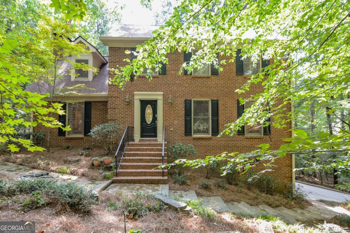Timeless Brick Beauty on One of Norcross's Most Picturesque Streets Nestled just moments from the heart of historic downtown Norcross, this classic four-sided brick home offers the perfect blend of privacy, character, and opportunity. Set on a lush 1.5-acre lot - which includes an adjacent half-acre parcel (R6273-055) - the property features a gently rolling creek, mature trees, and a sparkling pool surrounded by serene landscaping. Inside, the traditional layout welcomes you with a gracious foyer, leading to a formal living room and adjoining dining room - ideal for entertaining. At the rear of the home, enjoy a cozy fireside family room, a sunlit kitchen, and a charming sunporch overlooking the pool and natural surroundings. A convenient laundry area is located just off the kitchen. Hardwood floors throughout the main level Upstairs, the primary suite offers a ensuite bath and accompanied by three additional bedrooms and a full bath. Whether you're dreaming of a spa-inspired retreat or an expanded walk-in closet, there's ample potential to reconfigure the layout to suit your lifestyle. The kitchen also offers exciting possibilities for expansion and customization. Additional highlights include a generous garage with built-in storage and the rare bonus of a second lot - perfect for gardening, play and privacy. Why Norcross? This beloved town is known for its walkable downtown, vibrant dining scene, boutique shopping, scenic parks, and a welcoming community garden. Whether you're seeking tranquility or connection, this home places you at the center of it all.