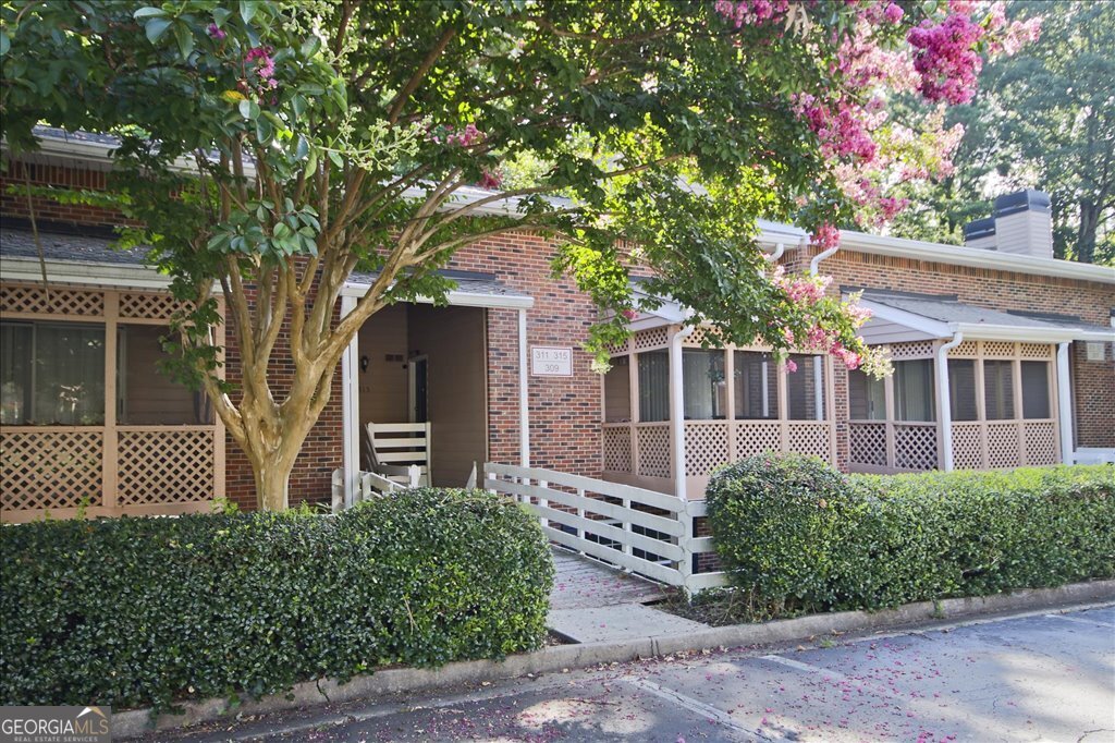 Welcome to your dream home in the highly sought-after Martins Landing neighborhood-a true gem where comfort, community, and nature come together in perfect harmony. Many deer strolling through your neighborhood. From the moment you step inside, you'll feel the warmth and functionality of this beautifully updated & maintained condo. The inviting vaulted living room welcomes you with a stunning stone fireplace, elegant new flooring, and updated lighting, creating a cozy yet spacious atmosphere that's perfect for both relaxing evenings and joyful gatherings. The heart of the home, the kitchen, is a standout feature-completely remodeled, & fully equipped with all SS appliances, ample cabinetry, and direct access to your own private balcony. Imagine sipping your morning coffee or unwinding after a long day, all while soaking in peaceful nature views. The main level offers a versatile bedroom that can double as a home office, guest room, or creative space-tailored to your needs. Full Bath has been remodeled. Upstairs, retreat to the spacious master suite, complete with a vaulted ceiling and a walk-in closet. Master Bath has been completely remodeled with custom features. Whether you envision a tranquil bedroom, a media retreat, or a personalized office, this space adapts beautifully to your lifestyle. Step outside to your screened front porch-a perfect sanctuary for morning reflections or evening conversations with friends and neighbors. This home has been lovingly cared for and thoughtfully updated. Even the washer and dryer are included, so it's completely move-in ready for you! Living in Martins Landing is a lifestyle. You'll enjoy 15 tennis courts, 4 swimming pools, playgrounds, walking trails around the serene 55-acre lake, and a stunning renovated clubhouse by the Chattahoochee River. The neighborhood is filled with lush greenspace and friendly faces, making every day feel like a getaway. You're just minutes from Downtown Historic Roswell, Canton Street, GA 400, shopping, dining, the public library, and it's an easy stroll to the local elementary school.
