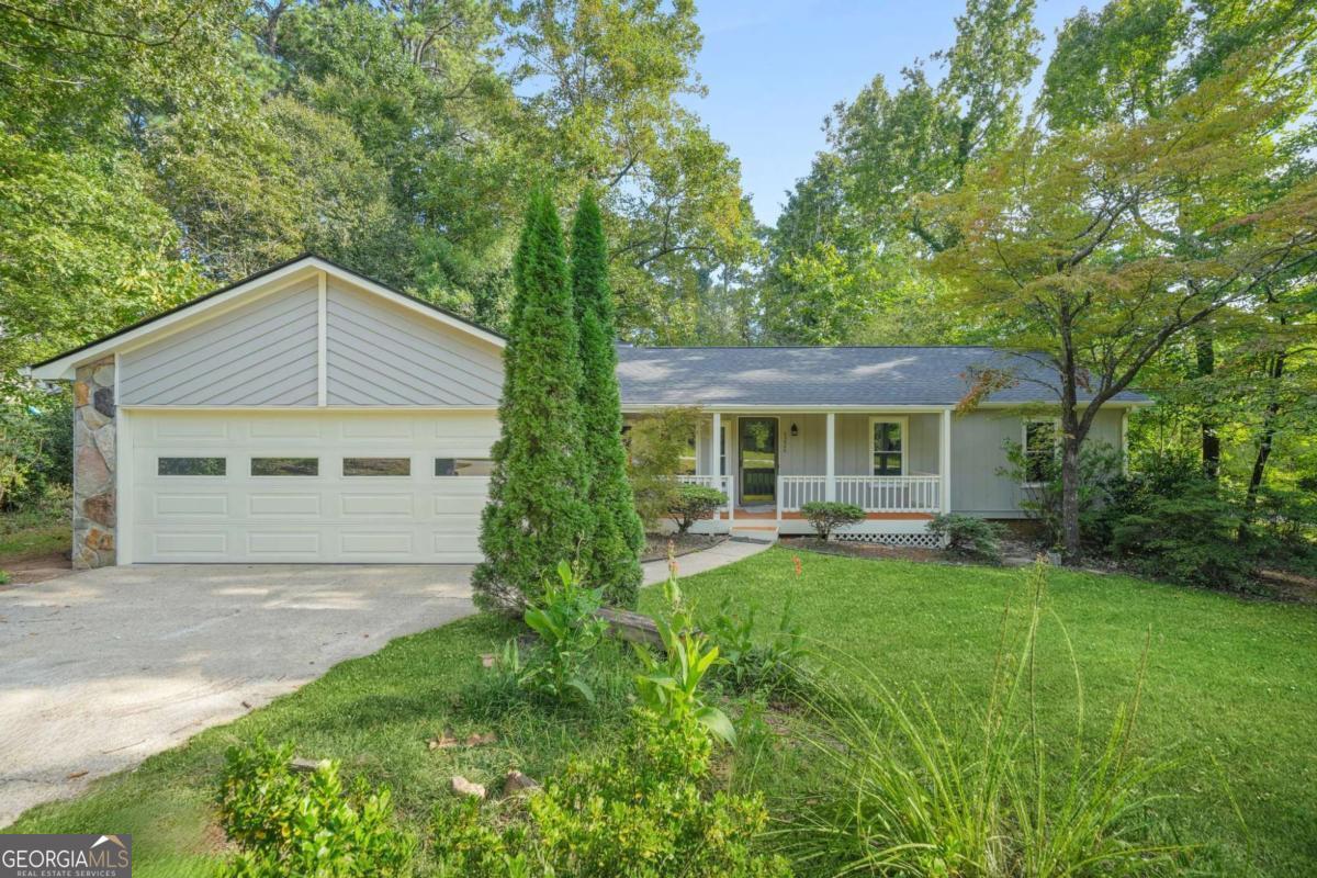 Better Than New, this beautiful one-level home sits on nearly half an acre in a peaceful cul-de-sac, offering the perfect blend of comfort, style, and convenience. From the moment you arrive, the freshly painted exterior and inviting curb appeal set the tone for what's inside. Step through the door and feel the warmth of a freshly painted interior that gives every room a crisp, modern glow. The kitchen is the true centerpiece, showcasing gleaming quartz countertops, timeless finishes, beautiful upgraded lighting, and brand new tile that flows seamlessly into the breakfast area. Matching quartz in the bathrooms adds an extra touch of sophistication. Luxury vinyl plank flooring extends throughout the living spaces, while brand new carpet in the bedrooms creates a soft retreat at the end of the day. Gather with loved ones around the cozy fireplace in the family room, or step out to the private back deck, perfect for grilling, entertaining, or simply enjoying the serenity of your oversized lot. Every detail has been thoughtfully upgraded, including brand-new Low-E windows, a brand-new roof, and the peace of mind that comes with them. Just minutes from Stone Mountain Park, major highways, shopping, restaurants, schools, and more, this home combines a quiet setting with unbeatable convenience. Homes like this don't last. Schedule your showing today and discover why this one truly feels better than new.