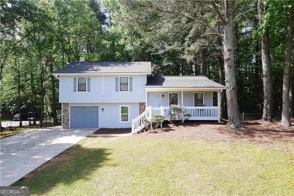Welcome to this beautifully renovated home featuring a charming rocking-chair front porch perfect for relaxing evenings and morning coffee. Step inside to an inviting open-concept floorplan with stylish laminate flooring throughout. The spacious Family Room flows seamlessly into the stunning Kitchen, which boasts a center island, sleek backsplash, stainless steel appliances, and crisp white cabinetry. Upstairs, you'll find the private Owner's Suite with a well-appointed ensuite bathroom featuring a Shower. Two additional bedrooms and a full hallway bath provide comfortable accommodations for family or guests. The lower level offers a versatile bonus room or fourth bedroom, a convenient laundry room, and direct access to the garage. Enjoy outdoor living in the spacious backyard complete with a storage shed. Move-in ready and full of charm -- this home is a must-see! 1-Year Rate Buydown Available! Our preferred lender is offering a 1-year temporary buydown for this property. This program will lower your monthly payments by a full percentage point for the first year. Call Shandy King at 404-557-4454 for full details!!