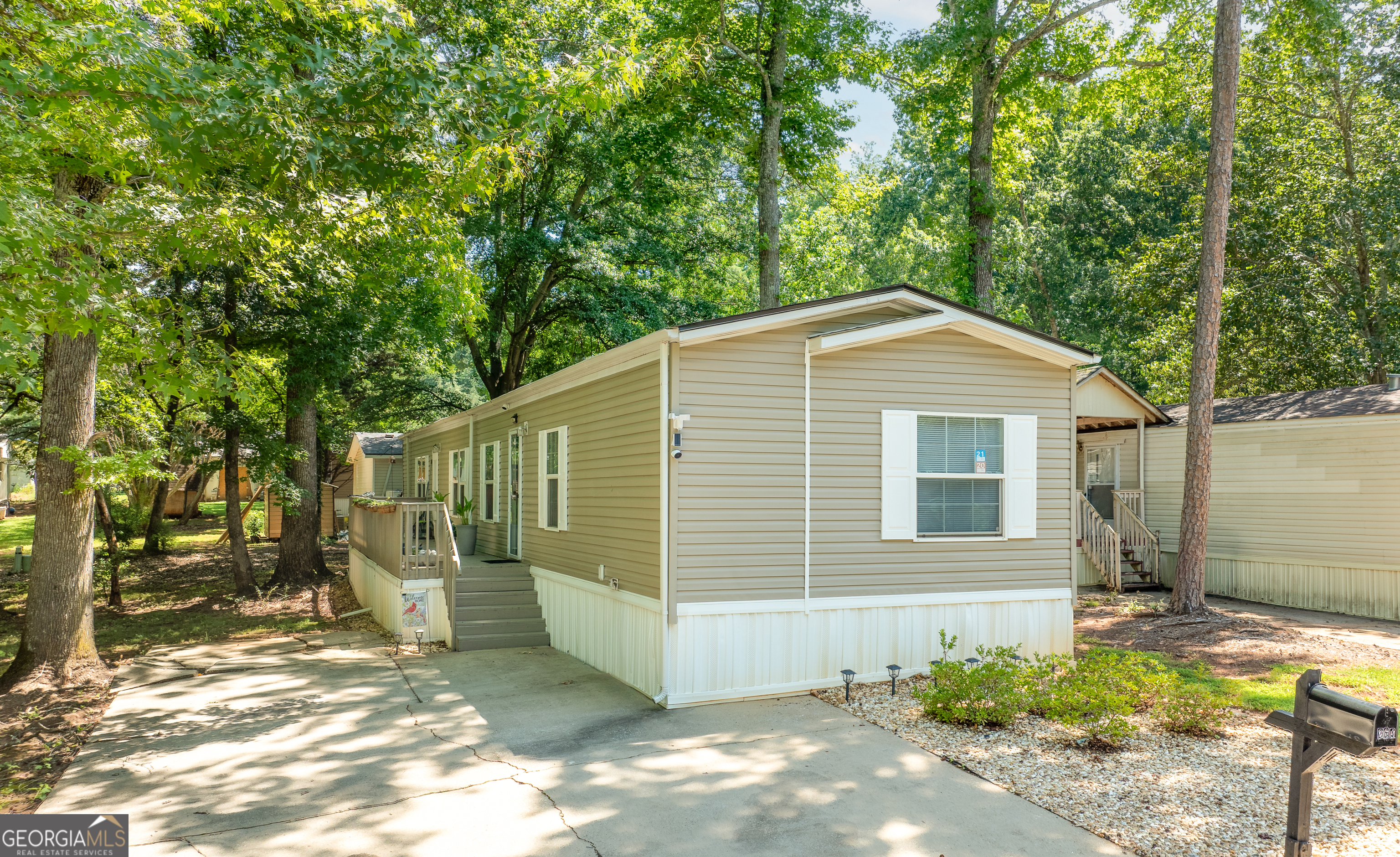 Fully renovated mobile home located in the sought-after city of Buford, just minutes from Lake Lanier and Margaritaville. This move-in ready home features a brand new roof (2024), new gutters and downspouts, new vinyl flooring, freshly painted kitchen cabinets, and all new appliances including stove, refrigerator, dishwasher, microwave, food disposal, washer and dryer. Both bathrooms have been remodeled. New lighting and ceiling fans throughout. Home includes a total of four closets plus a dedicated shoe closet in the main bathroom and a large closet in the living area. Spacious deck! Brand new metal shed stays with the property for added storage. Land lease is $802/month. Located in Countryside Village of Lake Lanier, a gated community offering resort-style amenities including a swimming pool, clubhouse, tennis court, basketball court, playground, dog park, and on-site church. Conveniently located near I-985, shopping, restaurants, and Lake Lanier. Affordable living in a prime location!