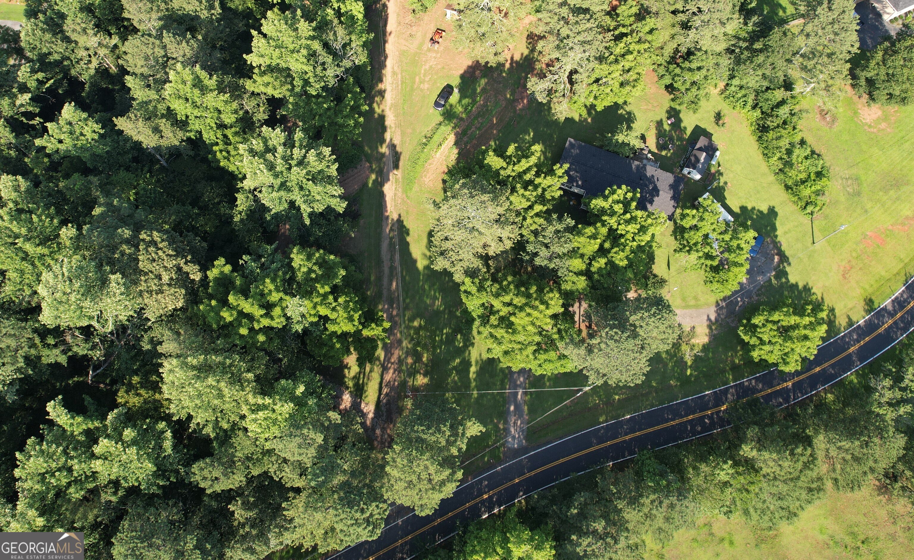 Opportunity to purchase additional adjoining lots for road frontage and even more land may be available. Discover the perfect blend of serenity and convenience with this 2.4-acre property, offering endless possibilities to build your dream home or more. With electric, county water connections, and an existing septic system from 2 prior homesites here, this property is ready to go! Surrounded by lush nature and abundant wildlife, including frequent deer sightings, this peaceful retreat features Fourmile Creek, complete with a beautiful sandy beach area perfect for relaxation or catching the occasional small fish. Nestled in an impeccable location, you will enjoy the tranquility of nature while being just minutes from schools, parks, Lake Lanier, and all the conveniences of Cumming. Shown by appointment only!