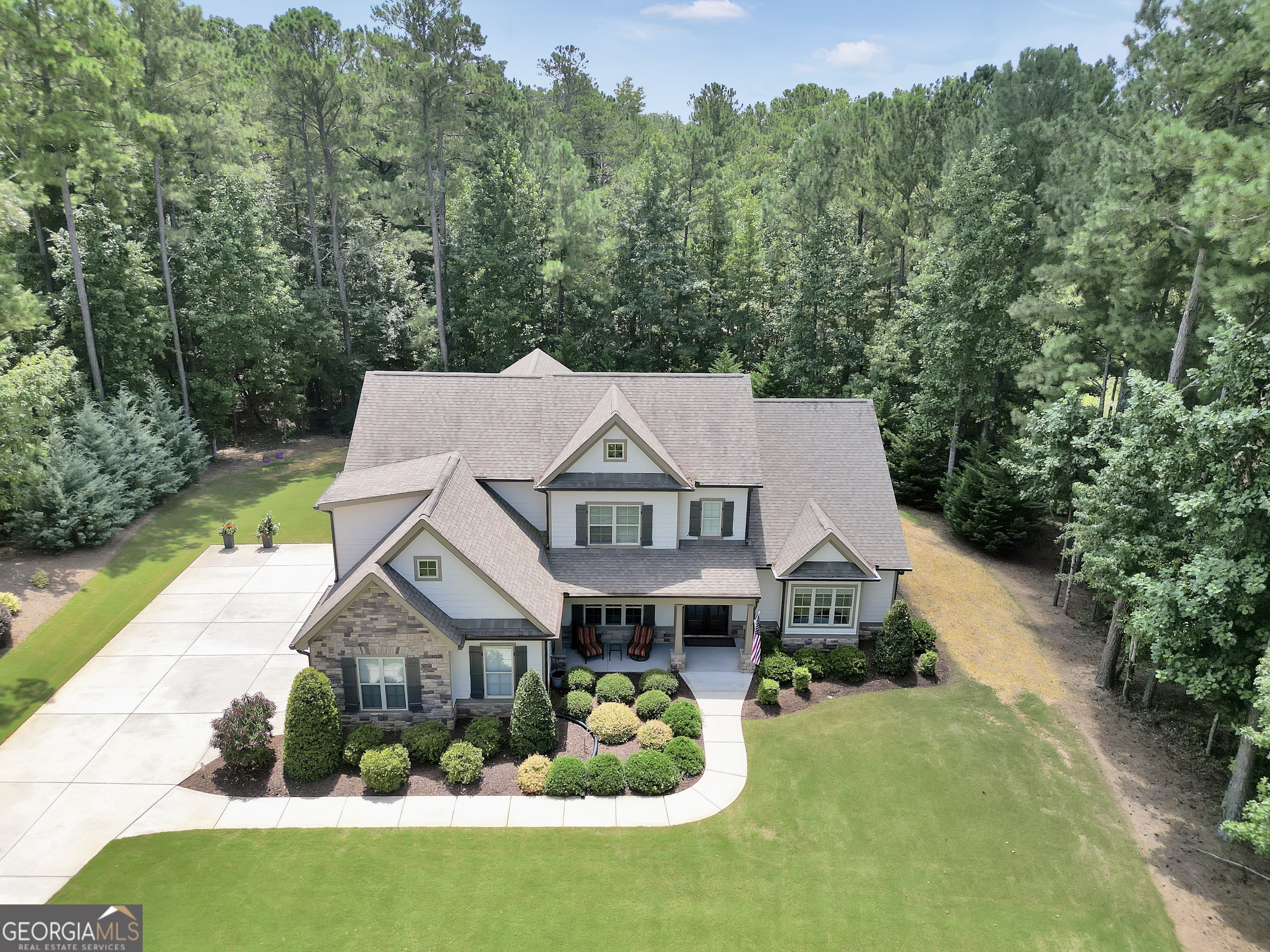 Welcome to your dream home in one of Coweta's most coveted communities-where only 24 custom-built homes were ever crafted, and this one just might be the crown jewel. Tucked in a quiet cul-de-sac, this immaculate 6-bedroom, 5-bath home has the space, style, and function you've been searching for. The main level features a luxurious master suite and an additional guest bedroom with full bath-perfect for in-laws, visitors, or a private home office. Upstairs, you have 4 additional bedrooms and 3 baths along with plenty of space for family, guests, or both. Better than new construction, the thoughtful finishes and upgrades shine throughout-from the brand-new double wall oven to the private, covered back porch that feels like your own personal retreat. Every detail has been meticulously cared for, making this home completely move-in ready. This home is the rare find you've been waiting for.