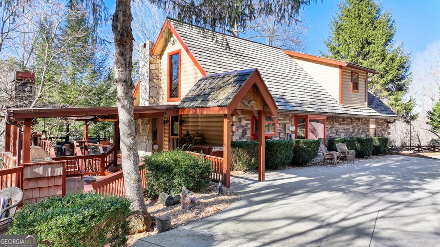 Welcome home to this beautiful oasis surrounded by the North GA mountains and panoramic view of a beautiful private lake shared in the Briar Cove community. Have you ever dreamt of owning an authentic log, mountain lodge? Well look no further! This four bedroom three full bath newly renovated and professionally designed home has every luxury one could hope for. The home boast five fireplaces, a spring fed pond adjacent to the home, panoramic view from several multi level balconies and covered porches that wrap around the home, all while encompassing a fabulous outdoor kitchen with a stylish Viking built in grill, refrigerator, wide counters and storage cabinets. Enjoy gourmet dinners from the beautifully designed open concept kitchen with hand honed leather granite counter tops, high end appliances and a generous island to entertain and relax in this well appointed kitchen. Gaze up at the grand vaulted, tongue and groove ceiling and to the one of a kind, hand crafted stair rail. The beautiful loft overlooks the two story living room/kitchen area to which it invites warmth from all around. The terrace level offers another master suite and grand master bath with jetted soaking tub. Full entertaining/gaming area. Brand new seven person hot tub overlooking the lake. Once wander outdoors, follow the beautifully landscaped path to your private dock. Ample in size to sun bathe, fish, launch your kayak, pedal boat, canoe, paddle board, or simply dive in and float the pristine lake. This home is a gem, a true one of a kind. Family and friends would love spending time year around, relaxing at your tranquil home on the lake. Short term rental is allowed. Owners achieved over $100k in revenue in first year as a rental. This premier property would make not only a wonderful home, but an excellent vacation property investment as well! This home has so much to offer and will not last.