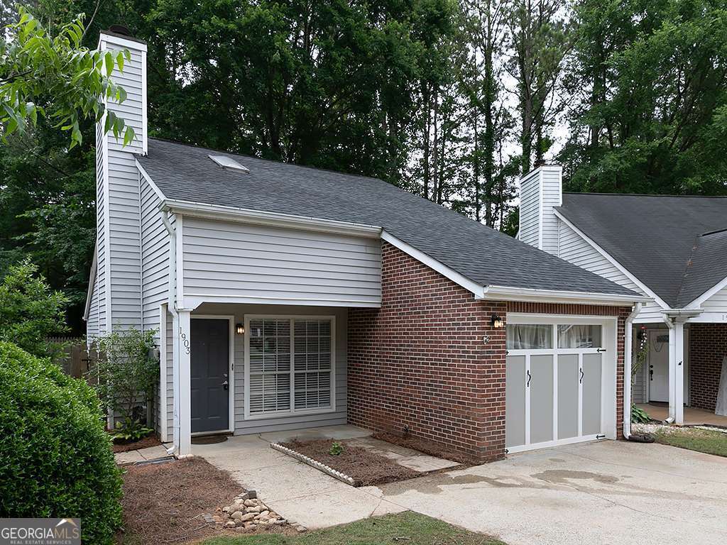 Back on Market: buyer financing fell through. Spacious 3-4 Bedroom Home in Prime Woodstock Location! Welcome to the largest floor plan in the community-ideally situated in the heart of Woodstock, just minutes from shopping, dining, and top-rated schools. This beautifully maintained 1.5-story home features 3 bedrooms on the main level, plus a versatile loft space upstairs accessible via a stunning wrought iron staircase. Whether you need a 4th bedroom, home office, or teen hangout, this flexible space has you covered. Enjoy the open-concept layout centered around a dramatic two-story foyer with a cozy fireplace as the focal point. The kitchen seamlessly connects to the main living and dining areas, making it perfect for entertaining. A converted garage adds even more heated and cooled space-ideal for a guest room or bonus living area. Step outside to your private, fenced backyard-perfect for gardening, relaxing, or hosting summer cookouts on the patio. This home truly combines comfort, style, and convenience in one of Woodstock's most desirable neighborhoods.