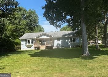 Very well built and maintained 3 Bedroom, 2 Bath home on gentle sloping lot on Lake Sinclair. Has screened porch on the rear and covered porch and deck on the lakeside. Beautiful hardwood flooring in greatroom. Just painted inside. Has 6" exterior walls so it's super insulated and efficient. Has ramp to porch and steps. Double car[prt and multiple outbuildings including one that has AC and makes a perfect workshop. Great view.