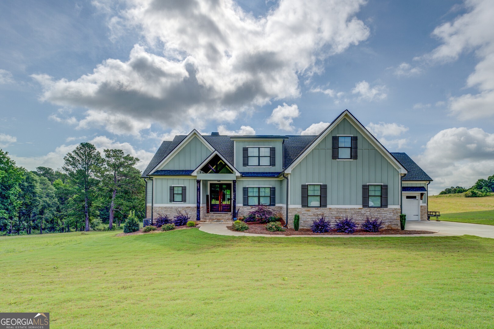 Welcome to your dream retreat on 2.76 tranquil acres located on East Lake Road! This stunning home, built in 2021, has been meticulously designed with countless upgrades and has barely been lived in, offering a like-new experience. Stepping inside, you'll be greeted by exquisite site-finished hardwood floors that flow seamlessly throughout, complemented by upgraded carpet in cozy areas. The heart of the home-an inviting kitchen-features custom cabinets, luxurious quartz countertops, and a top-of-the-line Thor 36" electric range oven, perfect for culinary enthusiasts. A spacious walk-in pantry ensures ample storage, while beautiful lighting adds warmth and charm to the space. The living room is a true highlight, showcasing coffered ceilings and a striking fireplace flanked by custom cabinets with live edge walnut tops, creating an atmosphere of elegance and comfort. Every detail in this home is thoughtfully curated, with upgraded millwork throughout. Retreat to the spa-like bathrooms, each complete with stunning tile baths and quartz counters that elevate your daily routine. Enjoy the convenience of a central vacuum system and the sophistication of custom powered blinds on all windows, ensuring your privacy and comfort at all times. Custom closets provide ample storage solutions for all your belongings. Perfect for entertaining or as a private escape, the bonus room offers endless possibilities, while a generous walk-in attic space provides even more storage options. The property doesn't stop there-this incredible home boasts 1254 square feet in the spacious 4-car garage featuring epoxy floors and a robust 400 amp electrical panel, accommodating all your vehicles and hobbies. This exquisite property is not just a home; it's a lifestyle opportunity waiting to be embraced. Don't miss your chance to make this elegant haven yours!