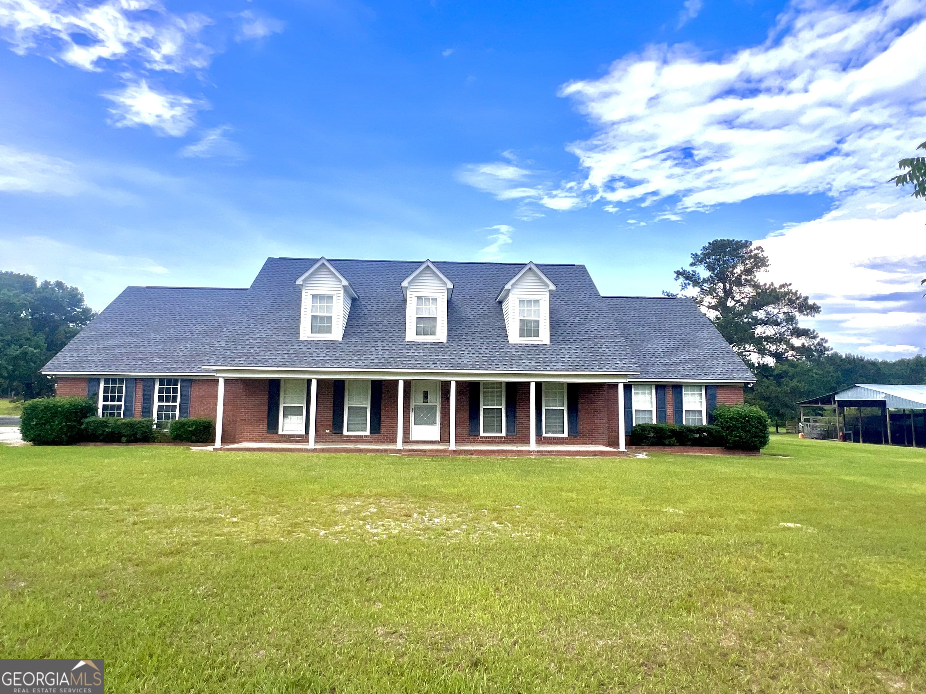 Nestled on 23.82 acres of serene countryside, this stunning ranch-style brick home offers the perfect blend of space, comfort, and natural beauty. With 5 spacious bedrooms and 3 full baths, this 3,685 sq ft layout is ideal for family living or hosting guests. This home boasts exceptional craftsmanship and ample space throughout. The heart of the home features custom cabinets with abundant storage, perfect for organizing your kitchen and living spaces. The home also includes a generously sized laundry room, featuring a large sink for added convenience that provides plenty of room for laundry tasks, storage, and organization, making chores easier and more efficient. Whether it's washing clothes or cleaning up after outdoor activities, this well-appointed laundry room is a functional and valuable addition to the home. Enjoy expansive living areas, including a large family room, formal dining room, and a cozy den-ideal for both relaxation and entertaining that feature laminate flooring throughout these three rooms and down the hallway. The oversized master bedroom offers a peaceful retreat with a generous double walk-in closets providing plenty of space for your wardrobe and more. The master bath features a double vanity, creating a spa-like atmosphere. There is also another large guest bedroom downstairs and another full bathroom. Up the beautiful staircase, you'll find a spacious and private second-floor retreat. One large room offers ample closet space, perfect for use as a guest suite, home office, or private living area. It includes its own full bathroom, ensuring ultimate privacy and convenience. Additionally, two more well-sized bedrooms are located on this level, providing plenty of room for family or guests. This versatile space enhances the home's layout, offering comfort and flexibility for any lifestyle. With 5 bedrooms and 3 baths, this home combines comfort and function, making it perfect for family living. Step outside to a charming concrete patio, perfect for grilling and enjoying the outdoors. Whether you're hosting a BBQ or simply relaxing in the fresh air, the brick patio adds an extra touch of outdoor living to this already impressive property. The property features a spacious garage with functional garage doors, offering plenty of room for a vehicle and additional storage. Beyond the house, a large pond adds to the serene atmosphere, complete with a private dock-perfect for enjoying tranquil views, fishing, or simply unwinding by the water. This combination of practical amenities and natural beauty makes this property truly exceptional. The property also features a well-equipped barn, a chicken coop, and multiple workshops, perfect for hobbyists or anyone seeking ample storage and workspace. Watch breathtaking sunsets from the comfort of your home, or step outside to fully immerse yourself in the tranquility this property has to offer. Whether you're looking for a serene retreat, room to grow, or a place to raise animals, this property is truly a rare find!