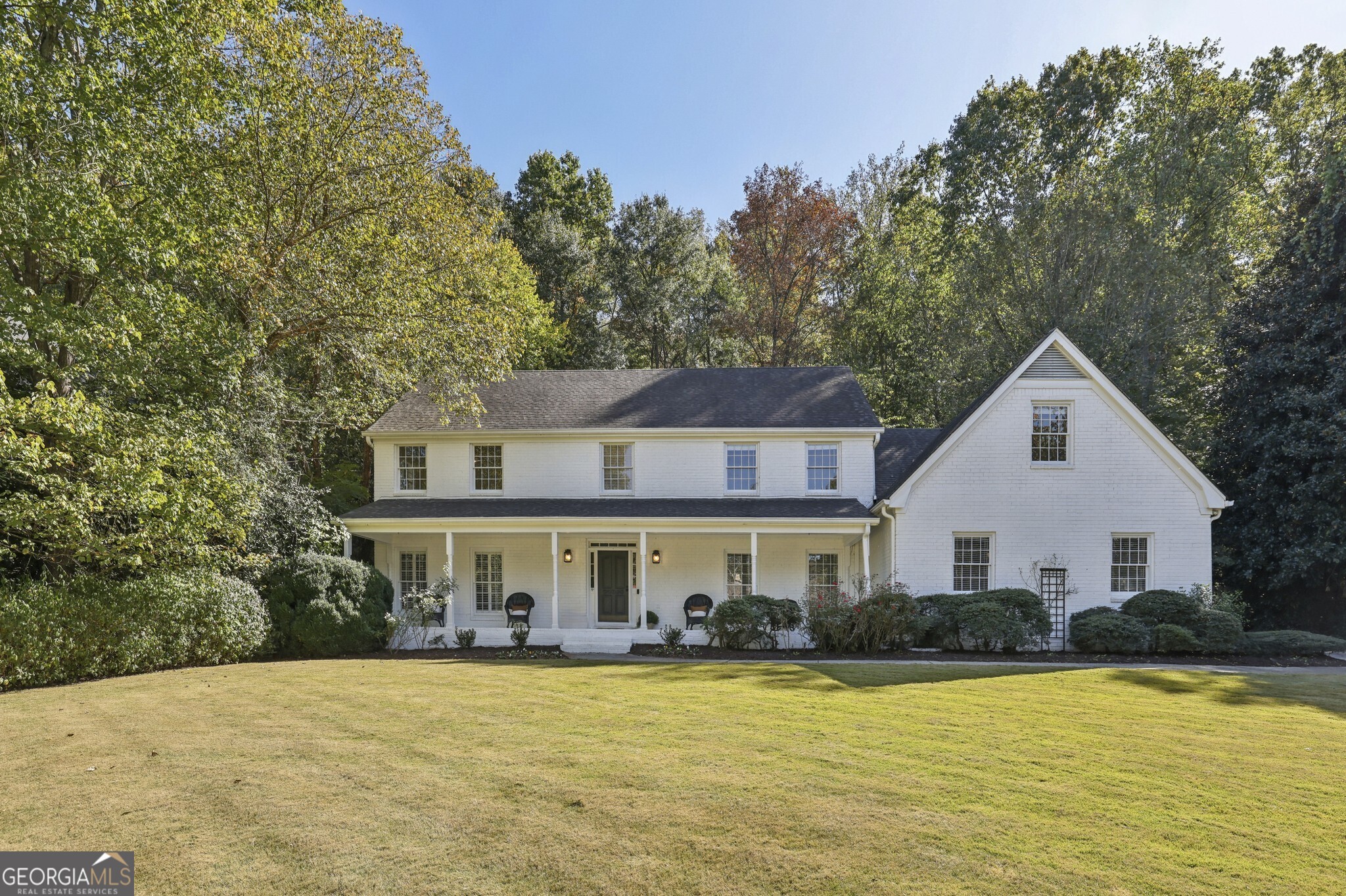 Southern Charmer with Private Pool in River Chase! A true Sandy Springs Oasis, this timeless White Brick Traditional is nestled in the highly sought-after River Chase Swim & Tennis Community, just steps from the Chattahoochee River. This beautiful residence on a Level Lot offers the perfect blend of Southern charm and modern comfort, complete with a Private Backyard Oasis featuring a Sparkling In-Ground Pool and lush wooded backdrop. The curb appeal will stop you in your tracks a Classic White Brick exterior with a Large Covered Front Porch welcomes you home. Inside, the Spacious Foyer sets the tone with Original Hardwood Floors, Wainscoting Details, Custom Wooden Shutters, and Crown Molding throughout. Natural light fills every corner, creating a bright and inviting atmosphere. To the left, a Formal Living Room centers around a Decorative Marble Fireplace. The Elegant Dining Room easily accommodates large gatherings and holiday entertaining. The Kitchen is designed for everyday function and timeless style, featuring Stone Countertops, White Cabinetry, Classic Subway Tile Backsplash, Stainless Steel Appliances, and a Breakfast Bar ideal for casual dining. A Breakfast Room adds additional seating and overlooks the serene backyard. The Fireside Family Room offers a warm retreat with Built-In Cabinetry flanking the Brick Fireplace and French Doors that open to the private patio and pool. A Bedroom or Home Office, Full Bathroom, and Laundry Room complete the main level. Upstairs, the Spacious Primary Suite offers room for a sitting area and includes Two Walk-In Closets and an Ensuite Bathroom with Double Vanity, Soaking Tub, and Separate Shower. Three additional bedrooms share a Full Hall Bathroom, and a Large Bonus Room provides the perfect Flex Space for a Playroom, Home Gym, or Media Room. The Unfinished Basement offers excellent storage and workshop potential, while the Two-Car Garage and Extended Driveway provide everyday convenience. Step outside to your Private Backyard Retreat, complete with a Sparkling Pool, Diving Board, and generous patio space perfect for entertaining or relaxing. Located in one of Sandy Springs' most desirable communities, River Chase is known for its Active Swim & Tennis Club, Tree-Lined Streets, and River Access. Enjoy two lit tennis courts, a sport court, pool and pool house with kitchen and grilling area, playground, bocce court, firepit, and year-round neighborhood events. Just minutes from Chattahoochee Recreation Area, City Springs, Buckhead, Downtown Roswell, and top-rated Public and Private Schools, this home offers an unmatched lifestyle of Privacy, Community, and Convenience.