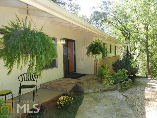 Welcome to urban living at it s best! This 1959 ranch brings mid-century / retro flair with a touch of modern chic! Gorgeous hardwood floors carry you throughout the main level. The fireside living room / dining room opens to the outside with sliding doors to the beautiful stone patio. The newly updated kitchen features high-end appliances, stone counters, lots of natural light, an abundance of storage, and plenty of space for multiple cooks and guests! A wall of built-ins and a large picture window with a million dollar view of the forest await you in the master bedroom. The downstairs rec room continues the theme of great style and functional built-ins, and opens to the sweet stone patio on the terrace level.