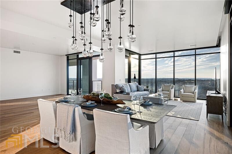Stunning 3 bedroom / 3 1/2 bath corner unit with incredible unobstructed views of the city from all directions that has never been lived in. Total privacy and controlled access with just one other unit on this floor. This unit has approx. 4300 sq ft of living space (3600 indoor & 700 outdoor) - three covered patios - a side patio with built in grill area accessed from the dining room, rear patio with stone fireplace overlooking the tree line & front terrace located off the secondary bedroom - all perfect for entertaining. The floor to ceiling windows throughout offers incredible views from sunrise to sunset! Truly a one-of-a-kind unit and location in Buckhead's newest luxury hi-rise offering a select 45 units. This very special residence features an office with floor to ceiling glass wall and door for privacy. The primary, secondary and powder rooms have all been renovated showcasing stunning selections from the state-of-the-art bidet in the primary bath to the oversized shower with body sprays and dual shower heads, and stunning light fixtures throughout. The gourmet kitchen features Wolf and Subzero appliances including full size wine storage, walk in pantry and laundry. Custom remote controlled window treatments are included. Reserved parking & storage is provided with controlled access as well. The residents of the Graydon enjoy a multitude of amenities from the concierge, valet, on-site property manager to the incredible amenity package with heated pool with lap lanes, outdoor fireside dining, spa, two parks specifically for your furry friend's enjoyment to fitness, dry sauna, indoor private dining room with catering kitchen and so much more. Truly a gem!