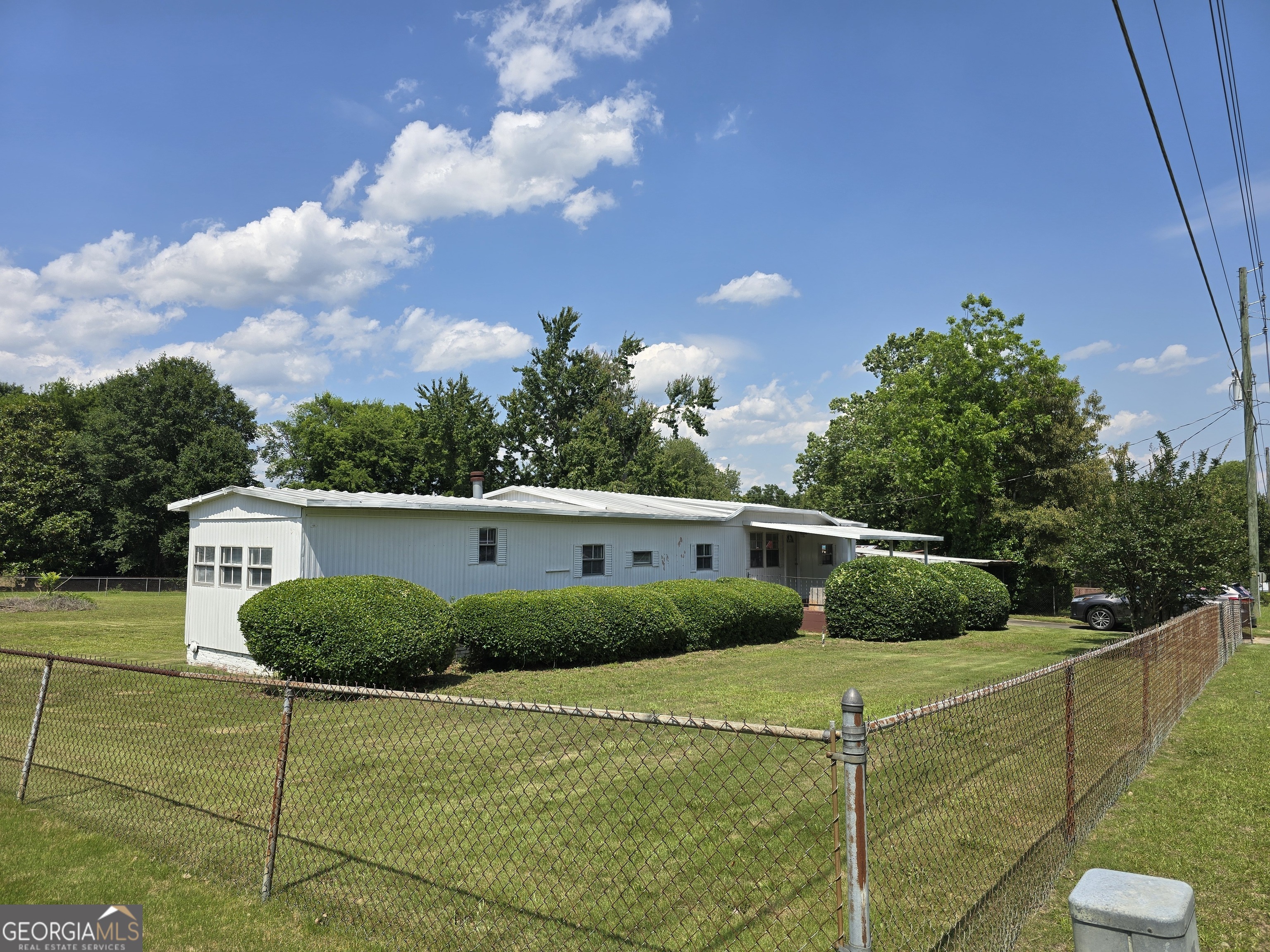 BACK ON THE MARKET AT NO FAULT OF THE SELLER: This move-in-ready manufactured home, set on almost half an acre, boasts: LARGE LIVING AREA: Perfect for gatherings. COVERED FRONT PORCH: Ideal for morning coffee. SPACIOUS, FULLY FENCED BACKYARD: Great for privacy and outdoor activities. 2-CAR COVERED CARPORT. OUTBUILDING/SHED: Excellent for storage. CONVENIENT LOCATION: Close to many of the amenities Houston County has to offer. SOLD AS IS. Call me or your favorite agent for a showing today?