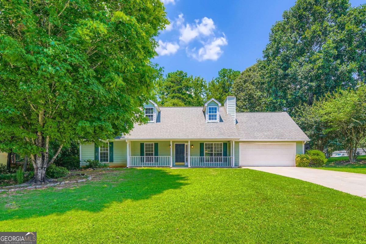 Step into this charming ranch-style home that combines classic character with contemporary features. Offering 3 bedrooms and 2 full bathrooms all on the main level, this home is perfect for easy, single-story living. The kitchen is a standout with rich wood-stained cabinetry, elegant granite countertops, and a full suite of stainless steel appliances-including an electric range, vent hood, refrigerator, and dishwasher. Enjoy low-maintenance living with durable laminate flooring flowing throughout the entire home. The spacious family room features a beautiful stone fireplace, adding warmth and charm. Perfect for cozy evenings or entertaining guests. The owner's suite features a spacious closet and dual vanities in the en-suite bathroom, offering both style and functionality. Situated on a level, flat lot, the outdoor space is ideal for gatherings, gardening, or simply relaxing on the inviting front porch. A 2-car garage adds convenience and extra storage space. Don't miss your chance to own this beautifully maintained and thoughtfully designed home. Schedule your showing today!