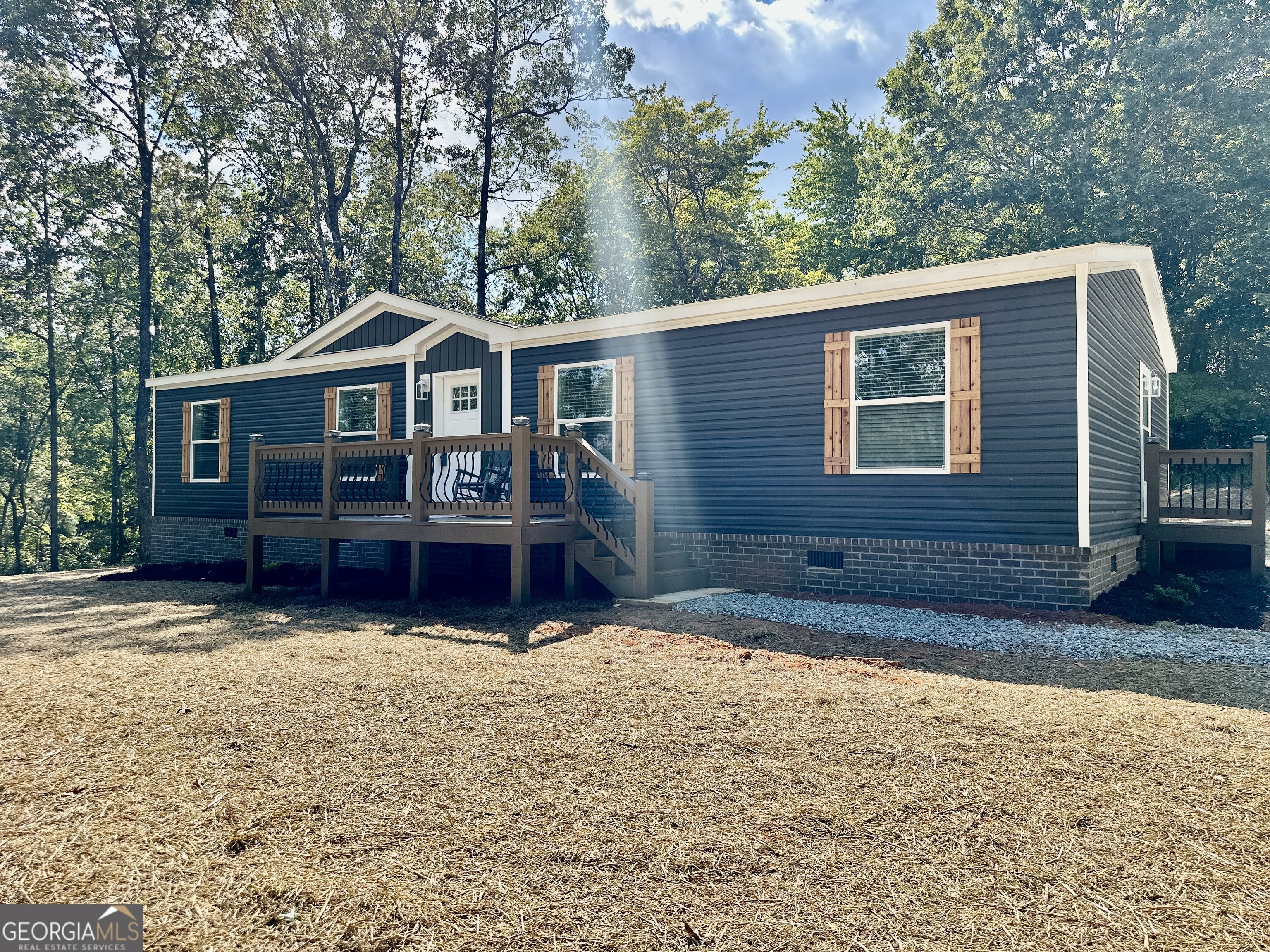 Another unique offering from Progressive Homes (PH); a premier land-home developer of Manufactured Homes in North Georgia- "Where Ordinary becomes Extraordinary. This sheet-rocked 3 bedroom, 2 bath home has an open floor plan and a large mud room with an area for an office space. It includes an all-brick permanent foundation, a heat pump, OSB wrapped exterior, custom stained decks, upgraded insulation, energy efficient windows, stainless-steel appliances, a remote-controlled electric fireplace, a programmable thermostat, and a double sliding door off the dining area leading to a custom-built deck. No expense was spared to provide a truly unique enhanced low-cost quality living experience. All Progressive Homes lots are graded to maximum use of your land, capture the best views, and provide for adding a garage or workshop where possible. This home meets all FHA, VA, and Conventional Finance Standards and includes a 1-year house warranty. See the attached pictures to view the details that distinguish a Progressive Home from others. See Plat, home is located on Lot 2. Tax records reflect the land only as home was not placed on property until 2025.