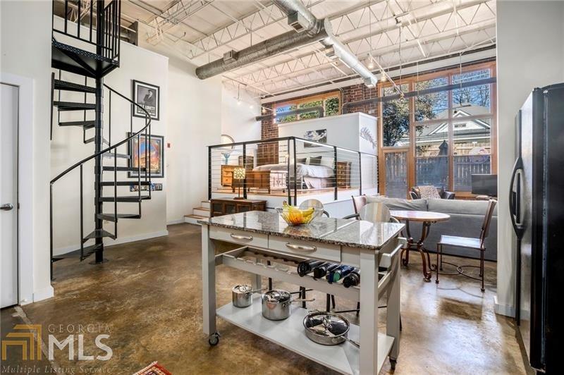 The best of all worlds awaits you in this light-filled loft in the heart of Reynoldstown. Enjoy soaring exposed ceilings, concrete floors, an open floor plan, updated kitchen, gorgeous renovated spa bathroom, walk-in closet, walk-in laundry and utility room, and a separate private loft for guests or a home office. Outside your living room a private fenced escape is ready for your morning meditation or happy hour with friends. The summer sun will find you poolside soaking up the rays or venturing through the private gate to the Eastside BeltLine Trail for access to the best of Reynoldstown and Intown living. Superbly surrounded by shopping, dining, entertainment and adjacent to so many of Atlanta's great neighborhoods, South Park Lofts is amenity rich in so many ways.