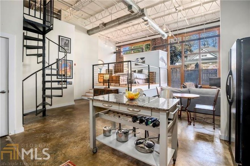 The best of all worlds awaits you in this light-filled loft in the heart of Reynoldstown. Enjoy soaring exposed ceilings, concrete floors, an open floor plan, updated kitchen, gorgeous renovated spa bathroom, walk-in closet, walk-in laundry and utility room, and a separate private loft for guests or a home office. Outside your living room a private fenced escape is ready for your morning meditation or happy hour with friends. The summer sun will find you poolside soaking up the rays or venturing through the private gate to the Eastside BeltLine Trail for access to the best of Reynoldstown and Intown living. Superbly surrounded by shopping, dining, entertainment and adjacent to so many of Atlanta's great neighborhoods, South Park Lofts is amenity rich in so many ways.