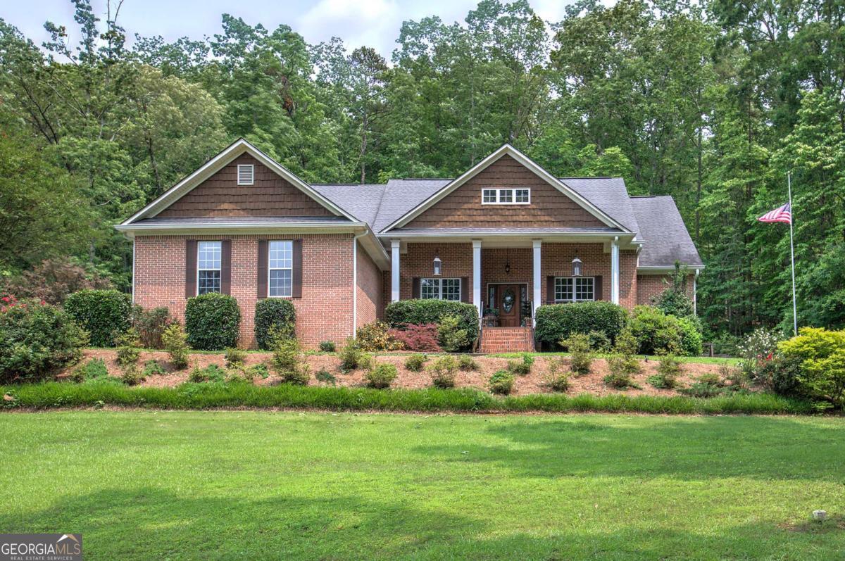 Welcome Home! This beautifully maintained four-sided brick ranch sits on over an acre and is truly move-in ready. Featuring four spacious bedrooms and three full bathrooms, the home offers hardwood floors throughout, custom cabinetry, a large living room with a beautiful brick fireplace, and a generous upstairs bonus room with its own full bath-ideal for guests or a teen suite. Step outside to your private backyard retreat, complete with an in-ground pool, covered patio, and fully fenced yard-perfect for relaxing, playing, or entertaining. Blending comfort, charm, and functionality, this property offers spacious living and peaceful surroundings you'll love coming home to-all while still being conveniently located near downtown Cartersville.