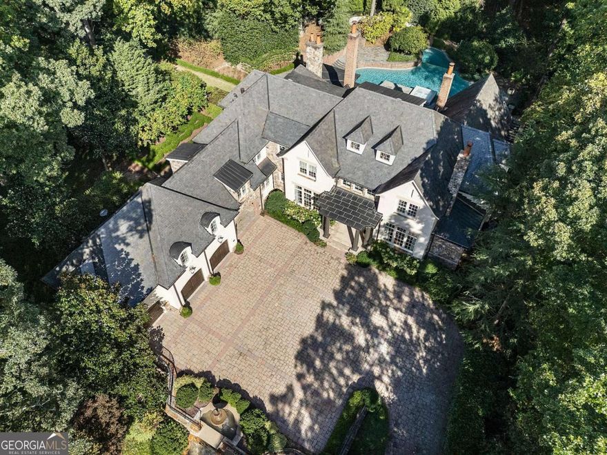 Spectacular private gated estate on 2.36 fenced acres, on a culdesac street in Buckhead. Perfect for walking with no cut through traffic. The residence is perfectly sited up a long driveway and overlooks the combined, separately deeded parcels.  Imagine your forever home surrounded by beautifully professionally landscaped gardens and walking paths.  Plenty of room to add a guest house if desired.  Double gates and completely fenced and private. Rare walk out pool and entertaining patios from the living, family room and kitchen.  Outdoor entertaining spaces with covered outdoor kitchen and fireplace. Walk on the trails all around the property.  Separate well for watering the landscape.  Separate monitored security for the neighborhood.  Exceptional builder, Tony Reaves, Intown Builders and Harrison Design architects created this masterpiece of brick, stone, copper gutters and a slate roof. The custom designed kitchen is open to the family room with brick barrel ceiling and fireplace and all opens to the pool.  The chef's kitchen has double Sub Zero refrigeration, drink drawers, icemaker and Wolf appliances, Calacatta gold marble countertops and custom Karpaty cabinetry. Plenty of storage capacity plus a walk in pantry. Ceilings throughout are 10 - 12 feet on all levels. Wide plank reclaimed hardwoods, solid doors and windows, six masonry fireplaces and stone floors on the terrace level showcase the quality of this spectacular home. This property is fully loaded with Control 4 technology, elevator, whole house generator, Control 4 lighting, security and music throughout.  Two primary bedroom suites, one on the main and one upstairs. There are four more on-suite bedrooms upstairs and a TV, study or game room.  Fully finished terrace level with bar, home theater, game room, gym, billiards and ping pong. Plenty of room for a golf simulator or larger gym.  Oversized garages and porte-cochere with loads of extra parking at the main house and on the side lot.  Enjoy a movie in the theater that seats 10+, spectacular redone double private pool, spa and waterslide. Major renovations and quality upgrades throughout. If you have been looking for the perfect private home in superb quality and condition, transitional and fresh, private and move in ready, this is it! Located in the high desirable 30327 and close to everything in Buckhead, Sandy Springs and Chastain Park.