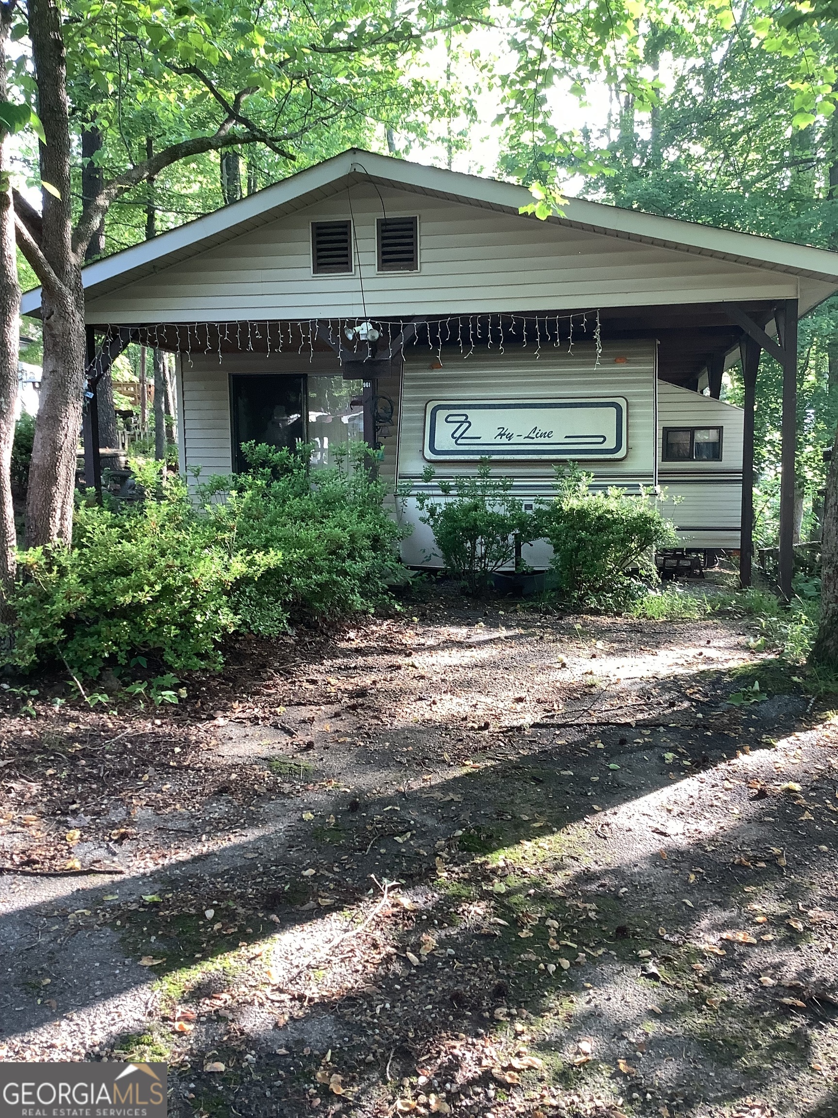 A 1994 2 bed and 1 bath rv with a large roofover and a room addition. Lots of windows in the room addition great for a large livingroom plus. 2 parking areas, covered porch. and within walking distance to the beach area. Located in a gated community with a clubhouse, 1 indoor pool, 2 outdoor pools, walking trails, 52 acre lake with a beach area, diner, country store, putt putt course, stables, a chapel and more.