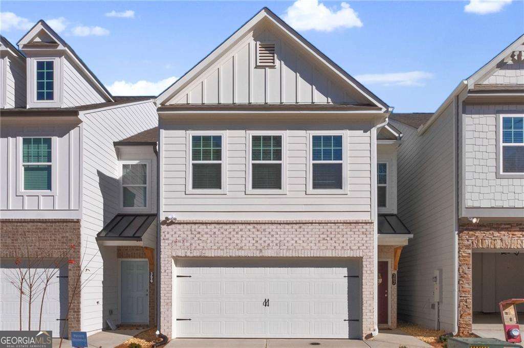 Nearly new single family detached home in conveniently located Pebblewood Grove! The floor plan features an open concept for everyday living or entertaining. The spacious kitchen features gray cabinets with granite countertops, tile backsplash & stainless-steel appliances. The HUGE island opens to an ample family room and dining area. Luxury Vinyl Plank floors extend throughout the entire main level. A backyard patio is available for relaxing or outdoor grilling. Upstairs features an oversized owner's suite with trey ceiling and walk in closet. The primary bath has an oversized shower with dual, raised height vanities and cultured marble top. Two secondary bedrooms share a tasteful hall bath. The laundry room is conveniently located on the second floor with a newer washer and dryer. The attached 2 car garage with carriage door and stone trim is complete with a 240V electric car charger outlet. The HOA takes care of routine lawn maintenance, exterior home maintenance and trash service. This a Canton address within the city limits of growing, vibrant Holly Springs. Minutes to Downtown Woodstock, Shopping, Home Depot, fitness, dining & I 575. Don't miss this opportunity to live in a brand-new home in a great location!! Application link - https://apply.link/kinuZyw Owner/Agent