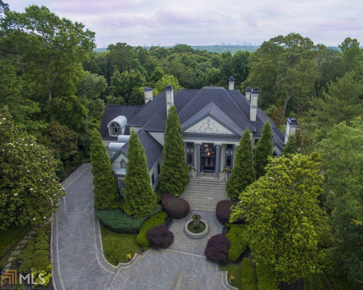 Private 2 acre +/- gated estate, long winding driveway with breathtaking approach. Grand two story foyer with amazing staircase, Gourmet kitchen views to vaulted keeping room. Custom hardwood flooring throughout. Two story fireside gentleman's study with spiral staircase. Private Owners suite with spa like bath, separate His & Hers closets. Terrace level features; custom bar & wine cellar, Egyptian themed theater, exercise room, with steam & sauna, elevator. Covered Loggia with outdoor fireplace, heated saltwater pool, spa with waterfall. Security & camera system. Self contained guest house with kitchen, bedroom with full bath & game room. Lighted tennis/sport court.