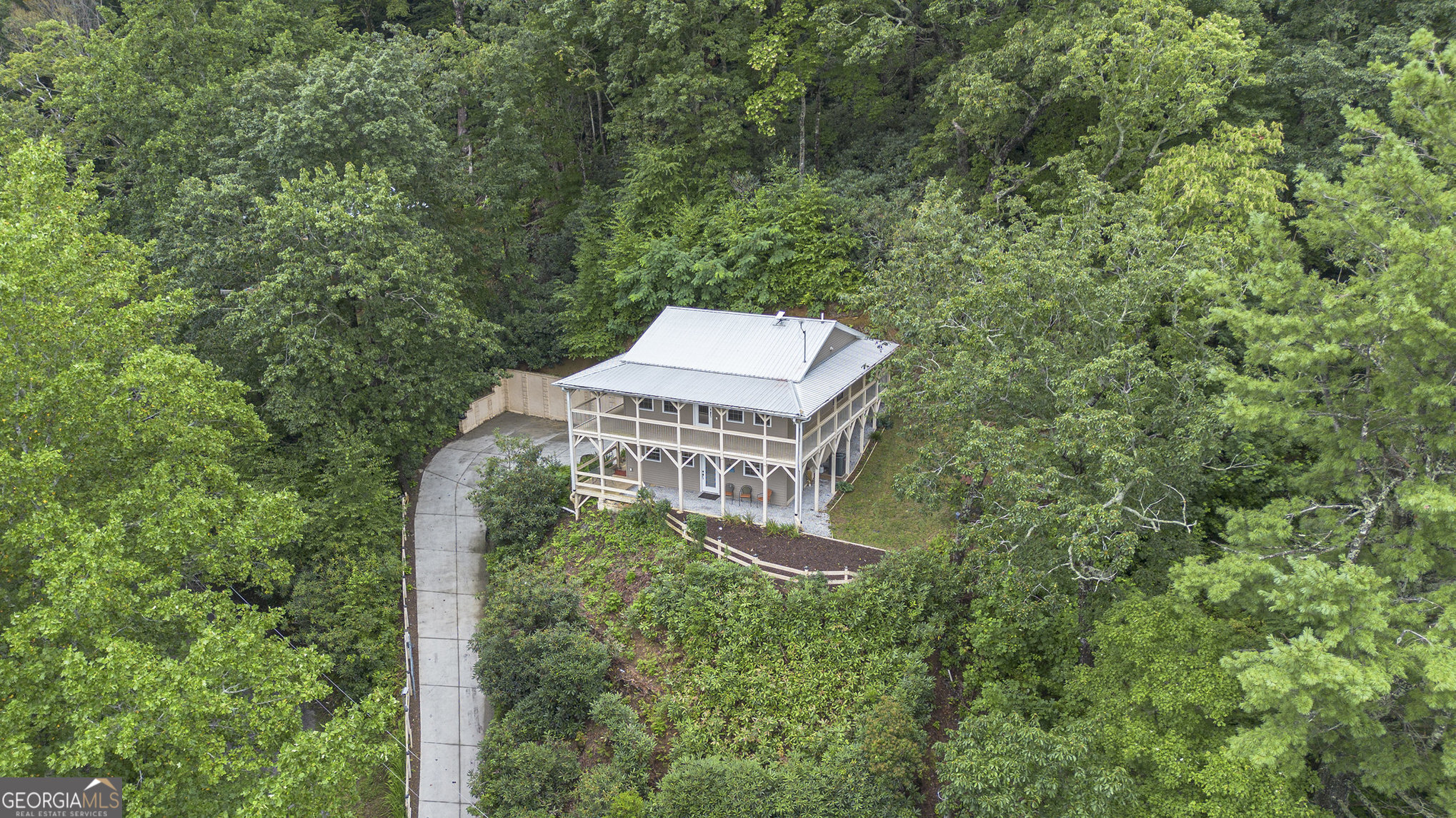 High above Clayton with incredible long range mountain views. Abundance of natural light throughout in this pristine home. Main level features kitchen with sliding glass doors to outdoor patio for entertaining or relaxing in nature. Second level accomodates family room and two bedrooms all with entry to wrap around decks for outdoor living. Attached garage with heat and air for parking or workshop. Starlink is available. Come relax in the mountains yet only minutes from the quaint town of Clayton with amazing restaurants, shops and plentiful out door activites.