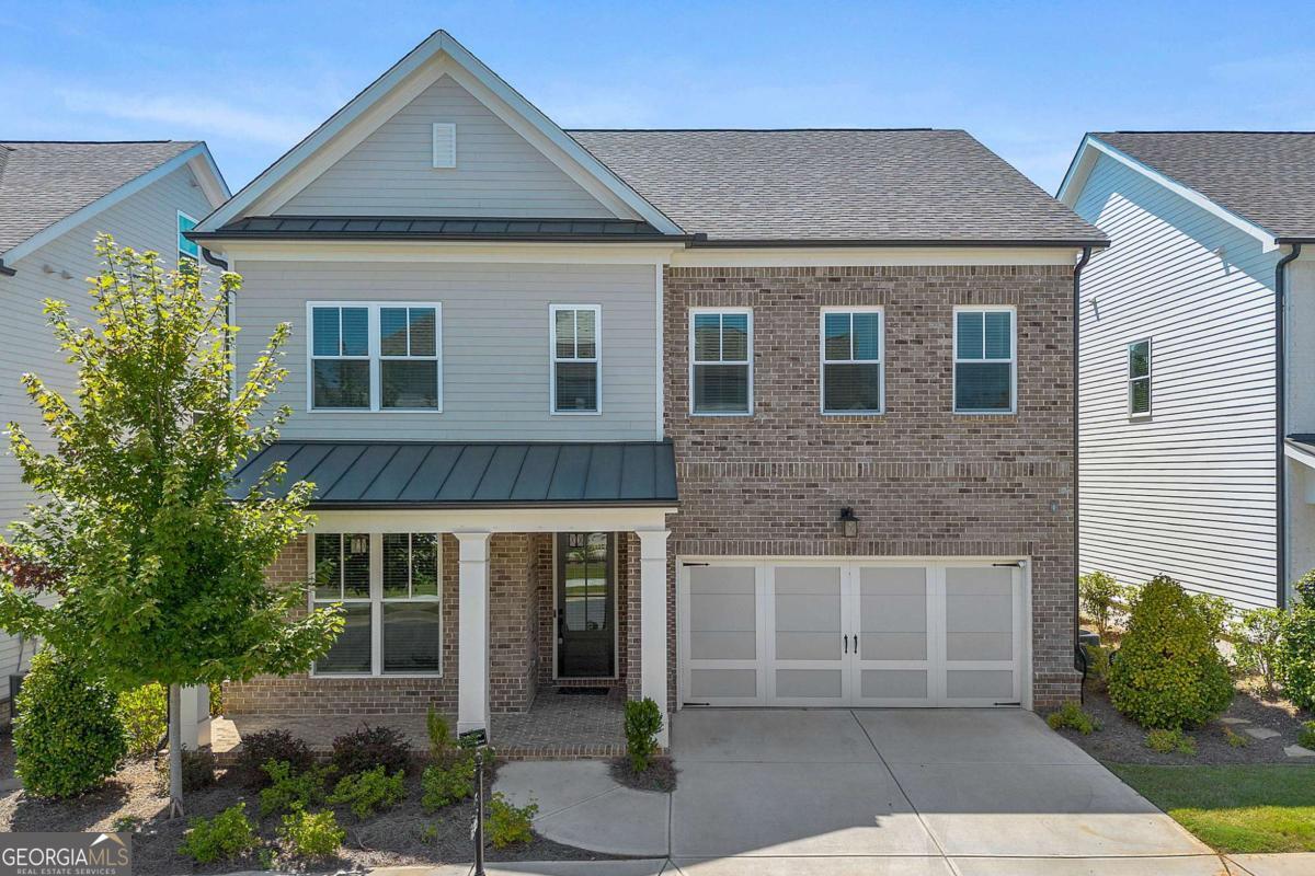 Welcome to this stunning NORTH-EAST facing home in the prestigious, award-winning gated community of Bellmoore Park, ideally located in the heart of Johns Creek and zoned for the highly acclaimed Northview High School. This coveted "Wesley" floor plan offers five spacious bedrooms and four full bathrooms, meticulously maintained and in excellent condition. A charming brick-and-stone front porch sets the tone, and as you enter the foyer, you're greeted by a bright, open-concept layout, soaring 10-foot ceilings on the main level, and modern, elegant finishes throughout. Gleaming hardwood floors span the main level, leading into a spacious family room with a cozy fireplace, abundant natural light & wholehouse water filtration system. A main-level guest suite with a full bath offers flexibility for visitors or multi-generational living. Upstairs, the luxurious owner's suite boasts a spa-inspired bathroom with soaking tub, glass shower, dual vanities, and huge walk-in closets. Four additional bedrooms and three full bathrooms complete the upper level, including a private suite with its own bath. Pre-wired Security system, Audio system on the main level and a car charging unit in the garage. The Bellmoore Park lifestyle is unmatched, with amenities including two resort-style pools, clubhouse, fitness center, tennis courts, basketball court, playground, and a scenic grand lawn. With HOA-maintained lawn care, top-rated schools, luxury finishes, and resort-style amenities, this move-in ready home truly has it all. Don't miss the opportunity to make this dream home yours!
