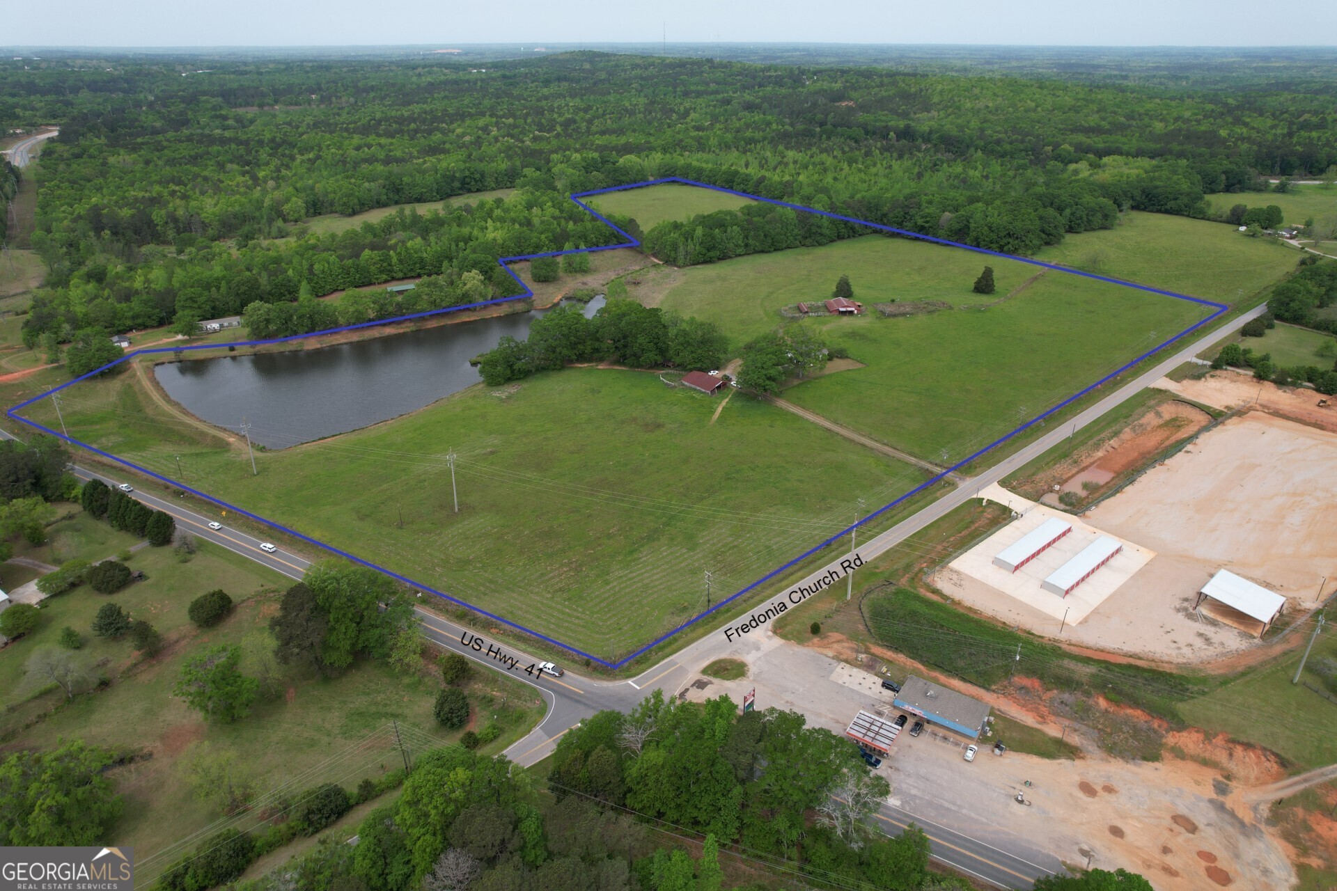 OWNER FINANCING AVAILABLE TO QUALIFIED BUYER. This beautiful property boast 47+ acres of mostly open, gently rolling pastures, fenced and cross-fenced, a 4+ acre pond, over 2400' of double road frontage, a 50 x 60 barn and several sheds and outbuildings and less than three miles from downtown Barnesville. Enjoy the tranquility of country living and the conveniences of the city. The House is a 1500 sq.ft. , 3 bedroom, 2 bath home with a full (poured concrete wall) basement that is partially finished, metal roof and a 2 car attached garage. One amazing feature of this home is the 55' cover, balcony porch across the back of the home. Enjoy sitting here early mornings or late evenings with a view of the pastures and pond. With just a little updating and cosmetics, this home could be customized to fit your needs. There are several beautiful building sites you could build your forever home and use this house as an in-law or other family home. Call today for an appointment to see this gorgeous property.
