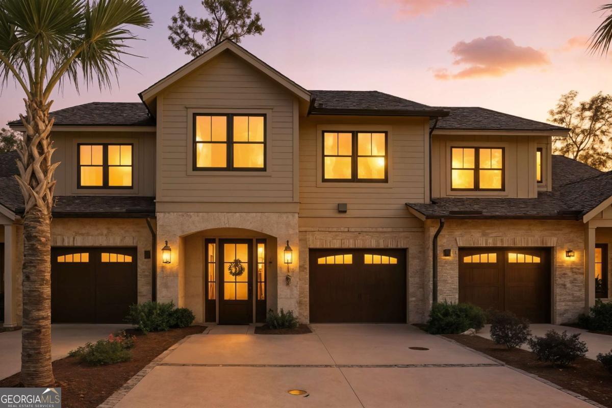Welcome to 147 Fifty Oaks Lane, a stunning 3 bedroom, 2.5 bath luxury townhome in the gated Fifty Oaks community on St. Simons Island. Built in 2024, this residence offers over 2,000 sq. ft. of elegant living with 10' ceilings and a spacious open floor plan. The chef's kitchen features quartz countertops, Bosch stainless appliances, gas cooktop, built-in microwave drawer, an island with breakfast bar, and pantry. The living area includes a gas fireplace and abundant natural light, creating a warm and welcoming space perfect for relaxing or entertaining. The dining area opens to a screened porch, then onto a patio overlooking the private, peaceful fenced backyard, complete with a grill with natural gas. Upstairs, the spacious owner's suite boasts a spa-like bath with soaking tub, separate shower, double vanity, and walk-in closet. Also, upstairs are two additional bedrooms, a full bath, and a laundry room with sink/cabinets. Elevator ready, this home also features tankless hot water, and a full-size garage. It combines modern design with timeless finishes including board-and-batten siding, brick, and hardy-plank exterior. Fifty Oaks features a landscaped gated entrance with gas-lit lanterns, a clubhouse, pool, serene pond views, and a breathtaking canopy of oaks throughout. Features are maintained by the HOA, including yard maintenance. This home & neighborhood offers an exceptional blend of style and island living.