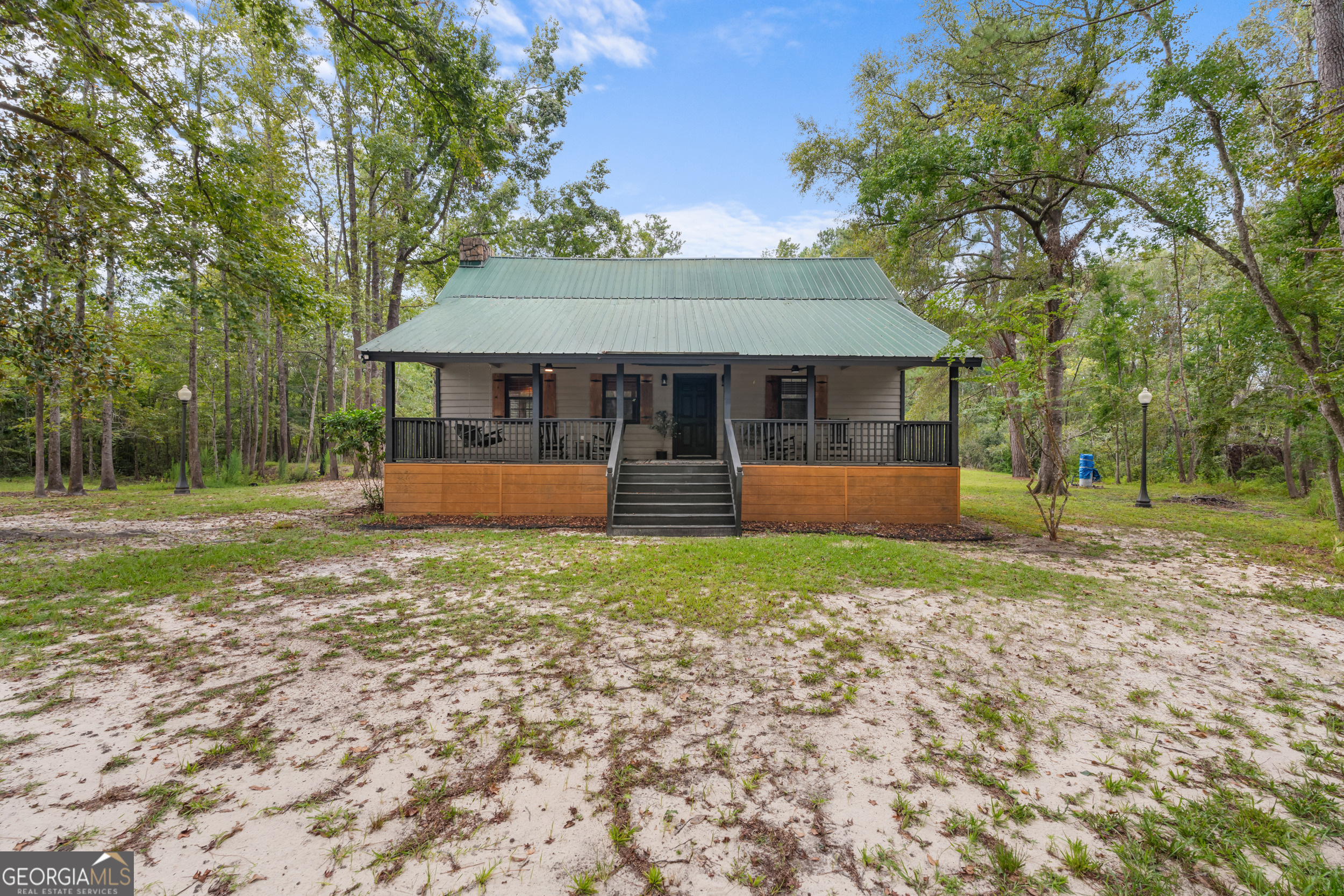 Waterfront Country Cabin on 10+ Acres - A Rare Metter Gem! Nestled right over the water, this charming 2-bedroom, 2-bathroom country cabin offers the perfect blend of rustic elegance and serene waterfront living. Step inside to a warm, open-concept layout featuring a stunning stone fireplace that anchors the cozy living room, a spacious loft for extra living or sleeping space, and plenty of natural light throughout. Set on 10.44 peaceful acres, the property boasts not one, but two private ponds - perfect for casting a line directly from your porch or simply soaking in the natural beauty. A quaint workshop designed to resemble a general store adds character and function, while a metal-covered carport with additional storage provides practical convenience. Whether you're looking for a quiet getaway or a full-time homestead, this property delivers privacy, charm, and unmatched tranquility - all just 7 miles from downtown Metter. Don't miss your chance to own this one-of-a-kind retreat!