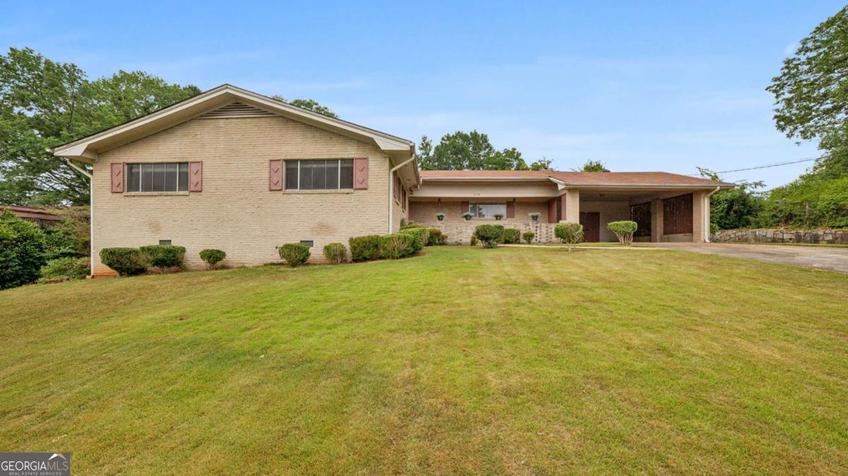 The PERFECT single-story layout with 1960s character on .5 acres! This L-shaped brick ranch features 3 bedrooms, 2 bathrooms, and laundry all on one wing, with a privacy door leading to the entertaining area in the other half. In absolute pristine condition, this home is perfect for those craving midcentury charm! There are vintage exterior light fixtures above the front courtyard, a fabulous kitchen with original cabinets and sink that overlooks the backyard, and gorgeous hardwoods throughout. As you enter the foyer with double coat closets, you're greeted with a designer's dream - ample space to customize with your personal touches. The den features an oversized fireplace spanning the entire back wall, with access to the patio and original brick barbeque area! The separate dining area is ready for entertaining and connects to a second living space. All 3 bedrooms have hardwoods and large windows, allowing an abundance of natural light. The primary suite features a private bath with original blue tile. Situated near parks and a lake in the quiet Churchill Downs neighborhood you don't want to miss this cozy charmer!