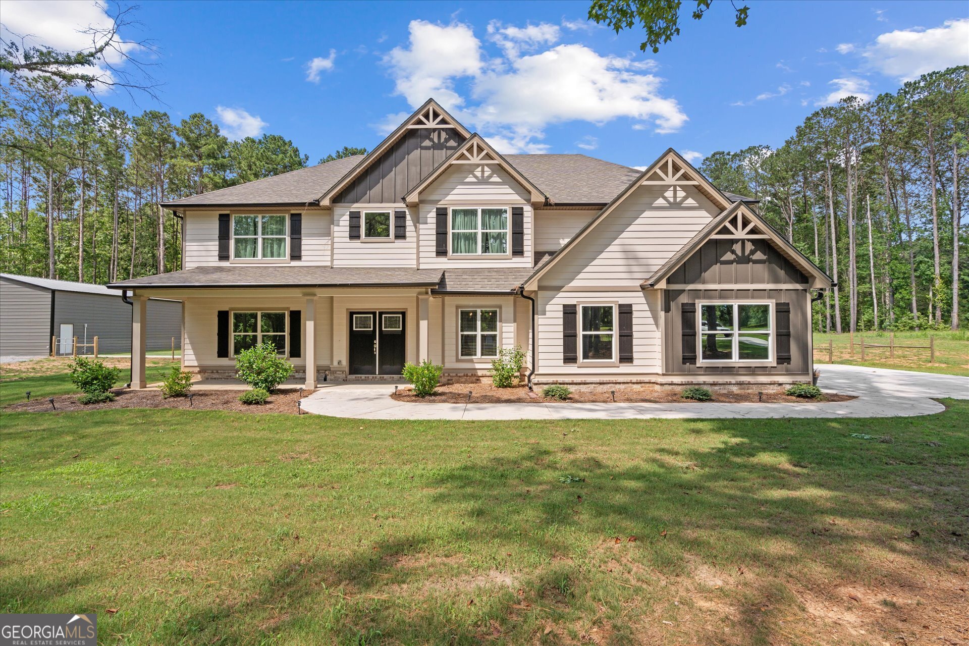 Experience the perfect blend of contemporary elegance and laid-back rural charm in this beautifully crafted 2023 like-new home, thoughtfully positioned on 5.91 acres of serene countryside. As you enter the home, you're greeted by a 2-story foyer with natural light filling the open-concept interior with high ceilings. Multiple patios off the main level invite effortless indoor-outdoor enjoyment and serene moments surrounded by nature. Tasteful upgrades elevate every space of the interior including a stylish accent wall in the separate dining room, sleek stone countertops, durable LVP flooring, and a spacious eat-in kitchen featuring a large island and breakfast area. This home offers 5 bedrooms, 3.5 bathrooms, and a multi-use loft that expands your options for a home office, game room, or bonus entertainment space. The main-level primary suite is a true retreat featuring a spa-like ensuite with a double vanity, soaking tub, tiled shower, and an oversized owner's closet. The exterior is equally impressive. A fully fenced landscape provides privacy and flexibility for pets or small livestock, while the impressive 46'x50' powered workshop -- featuring spray foam insulation and a separate circular drive -- serves as a dream space for storage or hobbies. Recent enhancements include upgraded French drains for efficient water flow, gutter guards for maintenance ease, two additional patio spaces, a paved walkway to the shop, and the transformation of the original patio into a screened porch for entertaining. This property offers the tranquility of country living without compromising sophistication, comfort, or functionality. The current owners poured their heart and soul into making this their dream home, but life's next chapter has led them out of the area, opening the door for someone new to enjoy this exceptional haven!
