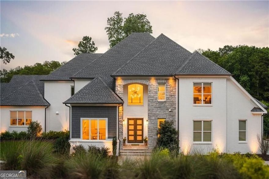 Exquisite like new luxury home overlooking the 15th Green in The Atlanta Country Club. Exquisite refined living in this meticulously designed residence, perfectly positioned with breathtaking views of the prestigious Atlanta Country Club golf course. The two-story foyer welcomes you with abundant natural light and gleaming hardwood floors that flow seamlessly through the main level. A sophisticated home office/den sits off the entry, complemented by an elegant formal dining room ideal for hosting intimate dinners or festive gatherings. The main-level owner's suite is a private retreat featuring a luxurious spa-inspired ensuite with dual vanities, soaking tub, separate shower, and expansive his-and-hers walk-in closets. The gourmet chef's kitchen boasts premium stainless steel appliances including a Sub-Zero refrigerator and Wolf gas range, sleek quartz countertops, custom white cabinetry, and a spacious island. An open-concept layout connects the kitchen to the soaring great room, where a wall of windows frames stunning golf course vistas and a cozy fireplace sets the tone for relaxed living. Step outside to the covered porch with its own fireplace - perfect for year-round enjoyment. Upstairs, there are four generous secondary bedrooms each offer ensuite baths and walk-in closets, along with a versatile loft ideal as a playroom, media space, or study area. The full terrace level spans the entire footprint of the home, featuring a private guest suite with full ensuite bath, state-of-the-art theater room, fitness center, wet bar, wine cellar, comfortable lounge area, and even a putting green for avid golfers. Three-car garage with EV charger. Exceptional craftsmanship, abundant natural light, and breathtaking golf course views make this home a rare find! Welcome Home!