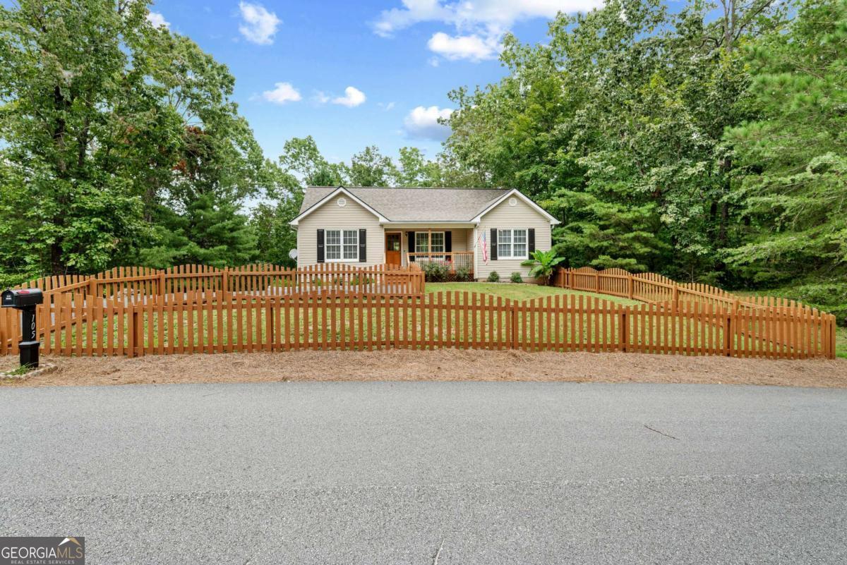 Step into an impeccably renovated home that offers the sleek comfort of brand-new construction offered at resale pricing. Experience the perfect blend of contemporary living and serene natural beauty in this renovated split bedroom plan home which includes 4-bedroom, 3-bath, nestled on a picturesque 1.3-acre lot in the sought-after community of Dahlonega. Every inch of this residence has been thoughtfully updated, featuring brand-new flooring, carpet, a modern open-concept kitchen equipped with state-of-the-art appliances, and elegantly remodeled bathrooms. 3 bedrooms and two baths on the main level with the lower level offering a versatile retreat, complete with a spacious bedroom, a full bathroom, an additional flex room and a dedicated workshop for the hobbyist and/ or DIYer - Step outside to discover a double-tiered deck that overlooks a tranquil, wooded backdrop, offering the perfect setting for morning coffee or evening gatherings. Significant updates include a new roof installed in 2020, a 2024 HVAC system, and an additional brand-new unit, ensuring year-round comfort and energy efficiency. Don't miss this opportunity to own a move-in-ready home that combines modern amenities with the peaceful ambiance of mountain living. Minutes from restaurants and shopping. Schedule your private tour today and envision the lifestyle that awaits you in this exceptional Dahlonega residence.