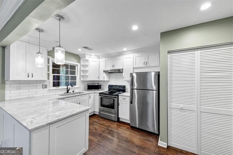 Beautifully updated 2-bedroom, 2-bath condominium in Cross Creek, a gated community spanning 113 wooded acres in the heart of Buckhead. This renovated 1,200 sq ft home features real hardwood floors in the main living areas, a wood-burning fireplace, and a light-filled sunroom-the perfect space for morning coffee or evening reading. The open-concept kitchen includes quartz countertops, white cabinetry, stainless steel appliances, and updated lighting, all flowing seamlessly into the living area and sunroom. The living room features real hardwood floors, a wood-burning fireplace with carved mantle and sconce lighting. The primary suite has a wall-of-closets with built-in's, window seat and bathroom with new vanity and storage tower, updated tile floor and shower. The second bedroom has a window seat and ample closet space. The hall bathroom features a new, contemporary vanity, new tile in the shower, new mirror and lighting. More storage is provided in hallway. The HVAC system and the water heater are approximately 5 years old. Cross Creek offers resort-style amenities including three swimming pools, four tennis courts, pickleball, an 18-hole par-3 golf course with a pro shop, and an on-site caf and restaurant with alfresco dining overlooking the golf course (open Tuesday through Sunday). The community also features an optional fitness center for $35/month. HOA dues include water, sewer, trash, landscaping, roof and building maintenance, road maintenance, the reserve fund, pools & tennis/pickleball. Located just minutes from Midtown, Downtown, I-85, I-75 and only 15 minutes from the airport. Cross Creek offers quiet, secure living with unbeatable convenience and charm. Truly "Atlanta's Hidden Gem!"
