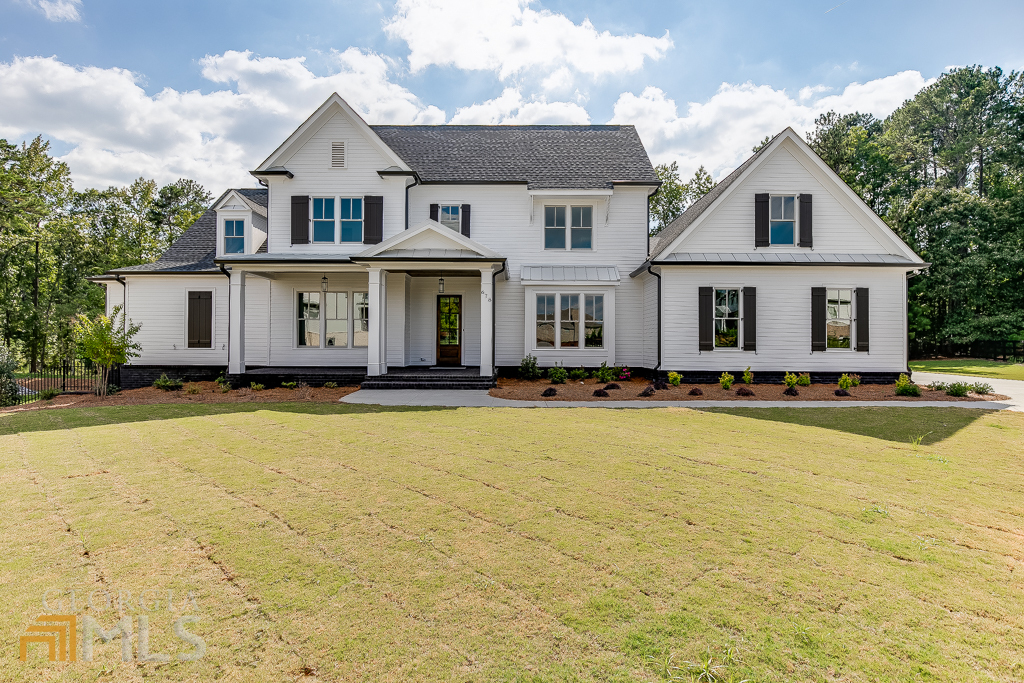 Modern farmhouse located in Suwanee in the desirable North Gwinnett school district. Built in 2022, this cul-de-sac home is situated on 1.3+ acres with a level driveway, large level landscaped front yard, deep front porch and serene backyard with nature views and massive grassed area. Room for a pool, tennis courts and a soccer field! Gorgeous owner's suite on main with spa like white bath, slipper tub, custom tile shower and huge walk in built out closet. Open concept floor plan with perfect entertaining floor plan. Family room features a fireplace in the family room and sliding doors that open to the covered porch. The family room opens to the chef's kitchen with oversized quartzite countertops. Kitchen boasts all stainless-steel Wolf, Sub-zero & Asko appliance package, Six Burner Gas Range. Butler's pantry leads to the formal dining room. The main floor also has a half bath and a separate Guest en-suite. Upper level holds three generous bedrooms, all with en-suite bathrooms and walk-in closets. Side entry three car garage is oversized and will accommodate the largest of vehicles. Room to grow with a large unfinished basement on terrace level. No detail has been overlooked!
