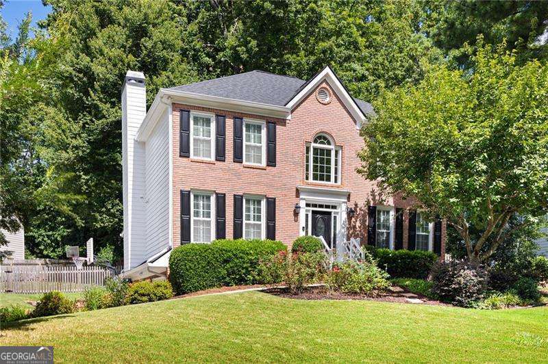 Do not miss this fantastic Brookstone beauty with a cozy in-law suite and a relaxing screened porch! Well-loved traditional style home with 4 bedrooms, 3.5 bathrooms, plus finished basement space with its own laundry room. Beautiful wood flooring throughout the main floor and LVP in the family room. Inviting eat-in kitchen with a breakfast bar and loads of counter space. Separate dining room with a stylish chandelier and crown moulding. Comfortable living room with built-ins and a brick fireplace. Spacious master suite with LVP flooring, a vaulted ceiling, and crown moulding. Updated master bathroom features his and hers vanities, a jetted tub, and a tiled shower. Finished basement is currently used as an in-law suite with its own full bathroom and laundry room. Large screened porch overlooking a fenced backyard with a paver patio and a fire pit. Newer roof, vinyl windows, HVAC, and water heater. This lovely home truly will not last.