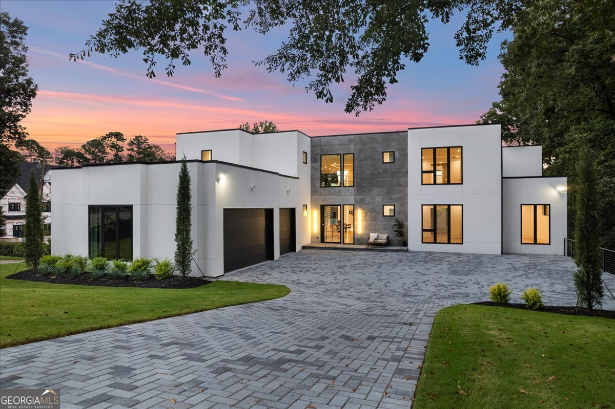 Extraordinary contemporary new construction home on quiet street in Chastain Park is now complete and move-in ready. The sprawling home is bathed in ample sunlight throughout the day and welcomes you into a breathtaking two-story foyer and great room with view to an elegant chef's kitchen complete with handsome custom cabinetry, Wolf and Subzero appliances, an oversized island with seating for 8, and a hidden scullery and pantry. Bright wide-plank walnut hardwoods flow through each living space, and the home is already equipped with an elevator to service all three levels. The thoughtfully designed home provides an expansive Owner's suite with a cozy fireplace and glass doors leading to the outdoor area. Double doors lead into the oversized marble and venetian plastered bathroom with generously sized dual vanities and his and hers water closets. Through another set of double doors leads into a massive closet - substantial enough to fit two large islands, furniture, and currently a blank canvas for buyers' taste of luxurious custom shelving to suit. Just beyond the great room, walk out onto a large deck complete with pool and spa for instant gratification. Upstairs features three additional spacious ensuite bedrooms and a secondary living space. The finished terrace level offers 11" ceilings, a second full kitchen and living area with a full view to a gorgeous glass wine cellar. A large gym, media room, large bedroom and full bath, plus additional unfinished space for ample storage. Home is already wired for Smart Home system and invisible speakers are already installed on main level. No detail has been overlooked to effortlessly make this home yours.