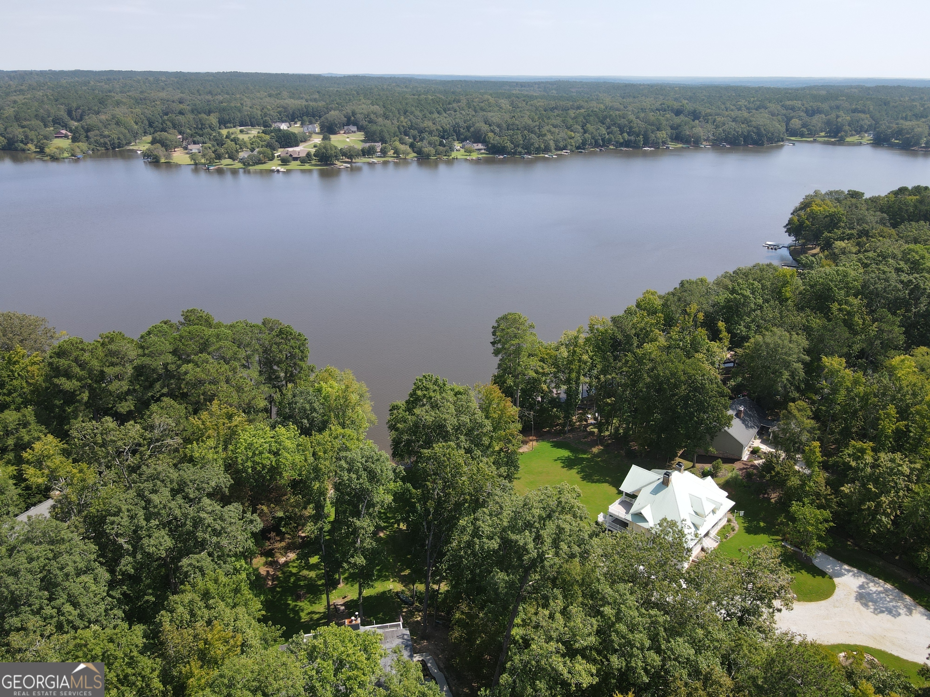 Seize the Opportunity to Build Your Dream Home in Oconee Shores! Imagine a 1.88-acre haven in the sought-after Oconee Shores subdivision, perfectly positioned just across from the tranquil Lake Oconee waterfront. This gently elevated lot offers a unique chance to design your dream home with the potential for seasonal water views right from your front door. As a member of the voluntary HOA, you'll enjoy exclusive access to community amenities, including a charming pavilion, a convenient boat ramp, and a dock-ideal for lake enthusiasts. Located just around the corner, these facilities enhance your lifestyle and make lakefront living even more enjoyable. This prime location blends serenity with accessibility, offering an exceptional foundation for your future home. Don't miss out on this rare opportunity to secure your slice of paradise!