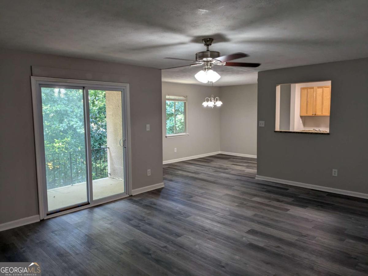 Private wooded views from your top-floor private balcony. 2 Bedroom / 1 bath single-level condo inside I-285. Bright, open floorplan featuring sliding glass doors to private balcony with additional locking storage closet. Updated bathroom and kitchen with stone countertops, all new appliances, and in-unit laundry hookups. Elegant, low-maintenance LVP flooring throughout. The inviting open-concept layout flows effortlessly from the front door past a sizable coat closet into the living room, where sliding glass doors lead to a private outdoor seating area with picturesque wooded views. The stylish dining area connects to a contemporary kitchen, boasting new GE Stainless Steel appliances, granite countertops, and sleek wood cabinets. Down a private hallway, discover two generously sized bedrooms, including one with a substantial walk-in closet. Both bedrooms share a beautifully updated bathroom featuring crisp white subway tile and an elegant aquamarine shower niche. Additional amenities include an extra locked storage closet on the private balcony and in-unit laundry for added convenience. Norgate Manor offers an exceptional living experience with a gated swimming pool, a clubhouse with meeting rooms, a serene wooded community park with barbecue grill, and designated dog walk areas. The recently refinished parking lot and a dedicated COA board of engaged owners enhance this tranquil community. Don't miss this opportunity-bring your offers today! Owner-agent.