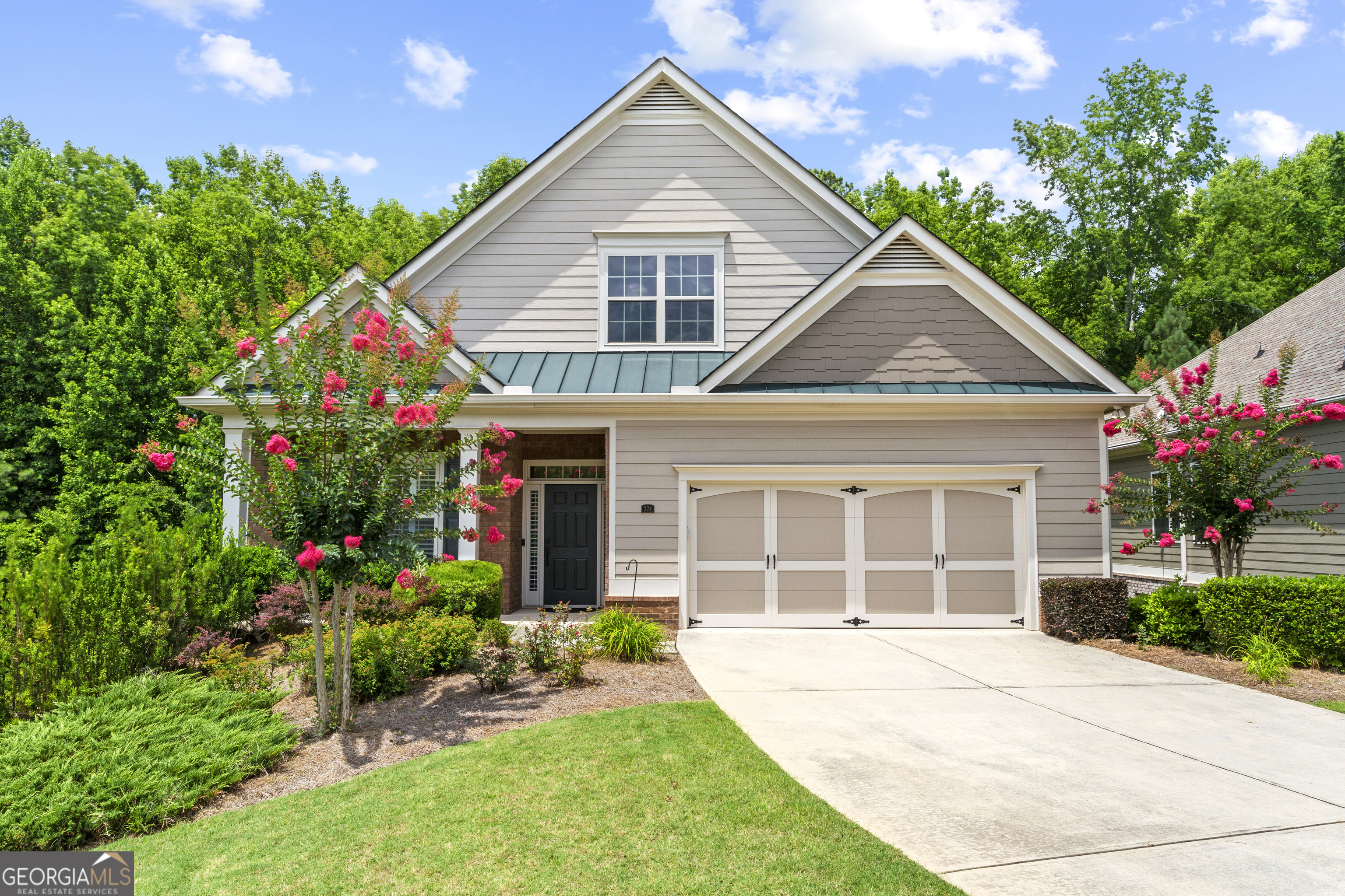 Welcome to the charming lifestyle offered at The Orchards of East Cherokee. This beautifully appointed ranch-style home features a fully finished basement, providing single-level living along with ample additional space designed with elegance in mind. Throughout the home, you'll find exquisite crown molding and hardwood floors. The stunning open-concept kitchen includes a pantry, and the home boasts spacious rooms, including a laundry room. A two-car garage with epoxy flooring adds to the convenience. An inviting sunroom and back deck overlook a lovely yard adorned with a serene wooded backdrop, while the lower level offers a screened-in outdoor living area of its own. You don't want to miss the delightful combination of comfort and style this home has to offer!