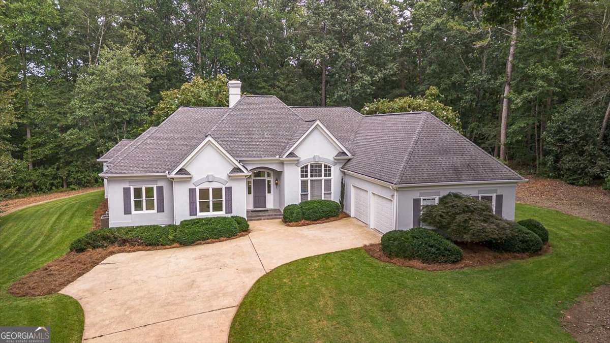 Elegant One-Level Home in Sedgefield - A Tranquil Retreat in Athens. Nestled in Sedgefield, one of the most beautiful and tranquil neighborhoods in Athens, This elegant 3-Bedroom, 3.5-bath home offers refined one-level living with seamless indoor-outdoor flow and exceptional design throughout. The thoughtful placement of windows invites natural light and stunning views of the surrounding trees and lush landscaping into every room. Upscale features include a range of ceiling heights, vaulted ceilings, a fireplace surrounded by custom built-ins, and a wet bar in the main living area and rich hardwood floors in the dining room and hallways. The kitchen is designed for both functionality and style, with ample cabinets and tile flooring that continues into the breakfast area and foyer. The expansive owner's suite is a private retreat, complete with a spacious bedroom and a serene sitting area with access to the outdoor living space, and a luxurious bath featuring a soaking tub, walk-in shower, triple vanities and custom closets. Ideal for entertaining, the open concept dining area accommodates large gatherings with ease while the breakfast area offers a casual space with direct access to the outdoor living area. Surrounded by thoughtfully landscaped grounds and mature trees, this home blends comfort and elegance in a setting that feels like a private sanctuary. All of this is just minutes from downtown Athens, shopping, dining, medical facilities and major transportation corridors-making this a rare combination of tranquility and convenience.
