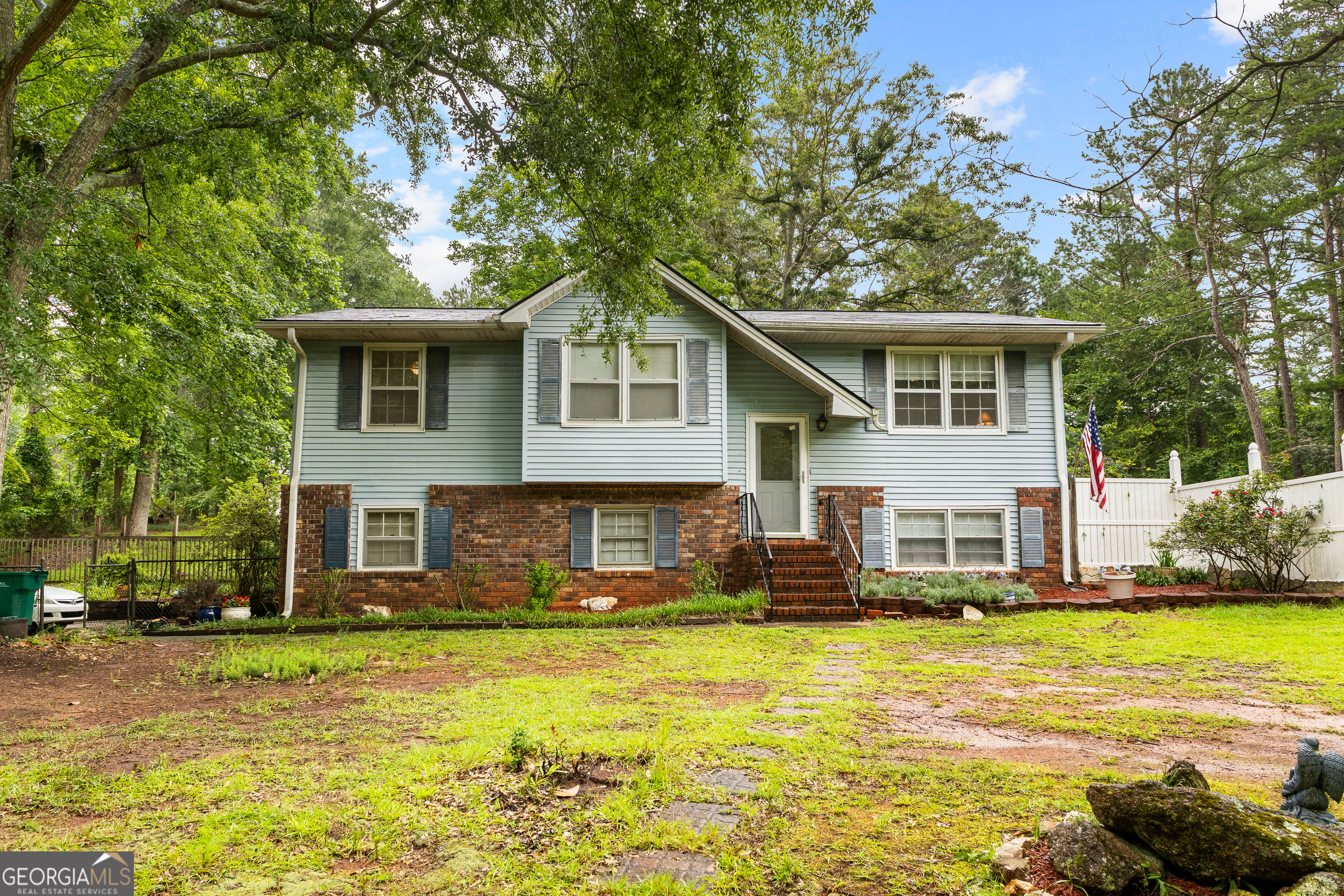 Welcome to 201 Greensprings Drive in Palmetto, GA-a charming split-level home situated on over half an acre. This 3-bedroom, 2-bath home offers a spacious and functional layout with a bright main living area and a versatile lower level that can be used as a family room, office, or playroom. Step outside to enjoy a large back porch that overlooks a generous backyard-perfect for entertaining, relaxing, or creating your own outdoor oasis. With an attached garage, mature trees for added privacy, and a peaceful setting just minutes from local amenities, this home offers the ideal mix of comfort, space, and potential.