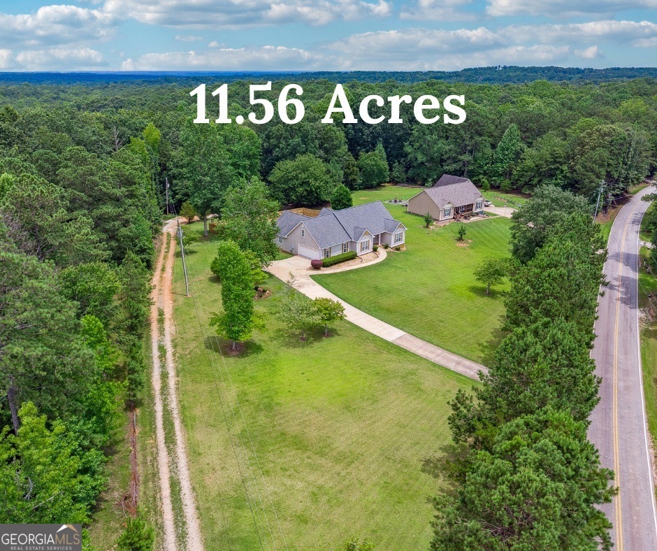 Welcome to a rare ranch offering space, versatility, and charm like no other. Set on a picturesque 11.5-acre tract of open pastureland, this beautifully updated estate features a fully renovated main house, a massive 24x48 barn/garage with a kitchenette, and a separate livable trailer with its own driveway-ideal for income-producing potential or multi-generational living. The main house has just undergone a stunning transformation, showcasing brand new flooring, fresh paint throughout, updated bathrooms, and a fully modernized kitchen. A spacious master suite anchors the home, complete with oversized closets and a luxurious ensuite bath. Two additional bedrooms and a full bath round out the main level, while upstairs you'll find a generous bonus room and plenty of unfinished space for future expansion or storage. Step outside to enjoy the newly built, partially enclosed deck overlooking a private, fenced backyard-perfect for kids, pets, or just enjoying peaceful afternoons in your own secluded oasis. The land surrounding the home is truly breathtaking, offering a rare blend of usability and privacy. Just beyond the backyard sits the large barn/garage, ideal for storage, hobbies, a workshop, or even conversion into more living space. The additional livable trailer, privately tucked away with its own entrance, provides the perfect opportunity for rental income, a guest house, or a home office setup away from the main residence. Whether you're seeking a homestead, a mini-farm, an investment opportunity, or simply room to breathe-this property has it all. Homes like this don't come around often.