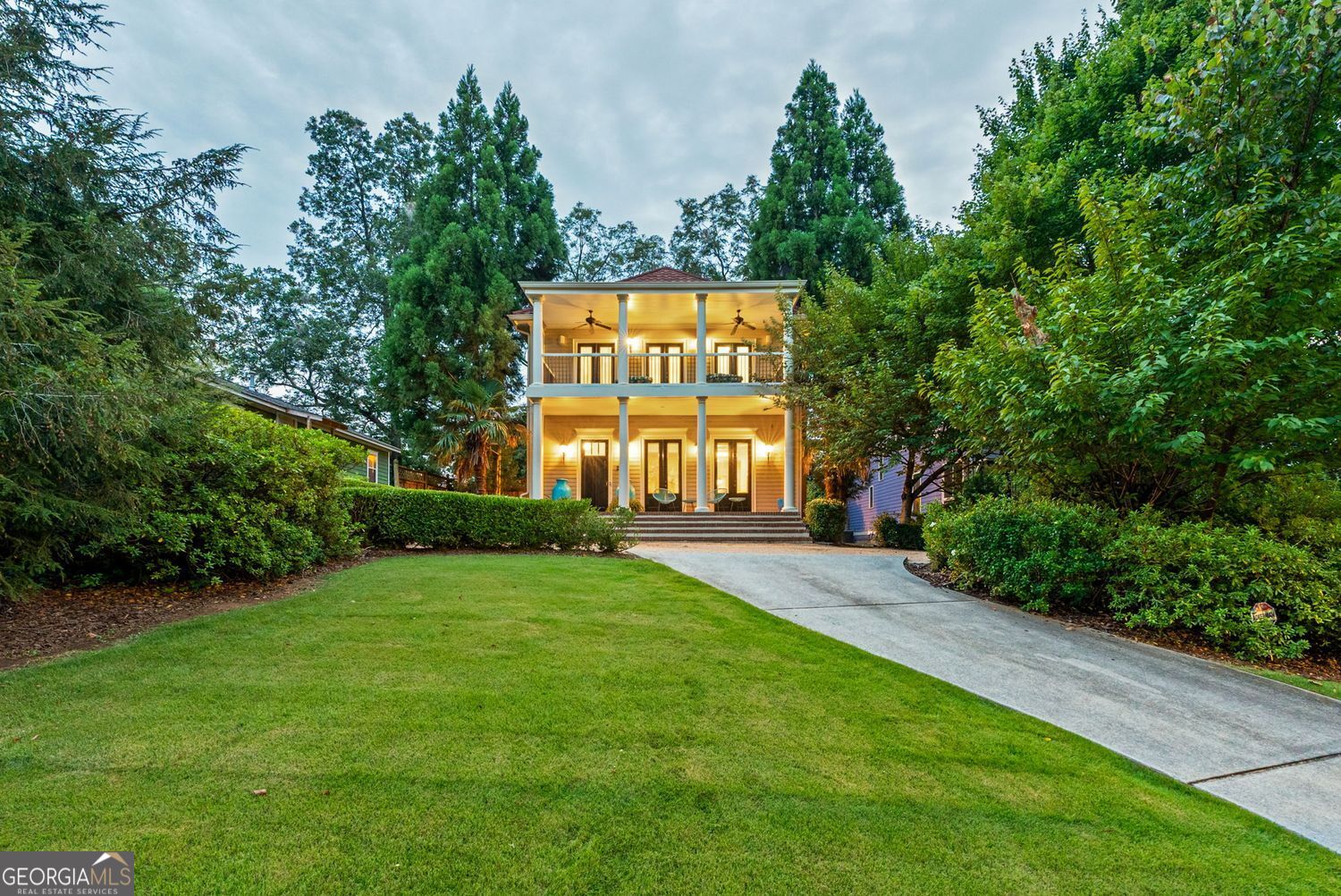 Custom-built in 2008 and thoughtfully occupied by its original owner, this residence was crafted with timeless detail and a focus on entertaining. From the moment you arrive, the home's wide front porch welcomes you with classic Southern charm. French double doors connect the front and rear porches, creating an easy flow for gatherings and opening the home to abundant natural light and breezes. Inside, the main level is defined by tall ceilings, expansive rooms, and exquisite architectural touches. The formal dining room showcases elegant box-beam ceilings, setting the stage for memorable dinners and celebrations. Just beyond, a warm paneled den with handsome pocket doors offers views of the rear yard-an inviting retreat for quiet evenings or lively conversation. Each space was designed to balance gracious proportions with livable comfort. Upstairs, the second floor primary suite is a true retreat. Featuring two walk-in closets, a luxurious soaking tub, and three sets of double doors that open to an expansive second-story front porch, the suite provides both comfort and connection to the outdoors. The covered porch becomes an extension of the living space, perfect for morning coffee, evening relaxation, or hosting guests with views of the neighborhood. Additional conveniences include a rear-entry garage with alley access and a versatile walk-up storage area above, ideal for future expansion, a workshop, or simply abundant storage. Every detail of this home reflects thoughtful design and enduring craftsmanship. Positioned just two blocks from East Lake Village and a short distance to both Kirkwood and Oakhurst Villages, the home offers quick access to dining, shopping, parks, and community events. Whether entertaining large groups or enjoying quiet weekends at home, this residence blends refined architecture, livable comfort, and an unbeatable location in one of Atlanta's most beloved neighborhoods.