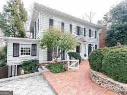 Stunningly renovated Colonial Revival home in the heart of Ansley Park, this 5-bedroom, 4.5-bath residence offers nearly 4,000 square feet of luxurious living space and timeless charm. Originally built in 1920 and fully renovated by Jones Pierce in 2016, the home features a gracious foyer that opens into sun-drenched formal living and dining rooms, both with working gas fireplaces and rich hardwood floors. The gourmet eat-in kitchen is a chef's dream with stone countertops, high-end appliances, a large center island with wine fridge, and a built-in breakfast banquet. A cozy den or home office with custom built-ins completes the main level. Upstairs, the elegant primary suite includes a fireplace, a luxurious en-suite bath with soaking tub and large walk-in shower, a custom walk-in closet, and a private screened porch with swing and outdoor TV. Two additional bedrooms share a well-appointed hall bath. The finished terrace level offers a spacious media and game room with built-ins, a wet bar with ice maker and wine fridge, a mudroom, full bath, and a charming bedroom with built-in bunk beds and study space. A detached two-car garage with dual Tesla chargers includes a beautifully finished carriage house above-perfect for guests, in-laws, or an au pair-with a Murphy bed, kitchenette, and full bath. Outdoor living is just as refined, with a private screened porch and professionally landscaped lot just steps from Piedmont Park, the Atlanta Botanical Garden, the BeltLine, and Midtown's cultural institutions. This rare Ansley Park gem blends historic character with modern amenities in one of Atlanta's most coveted neighborhoods. This home may not be sub-let or offered by tenant on AirBNB VRBO or any other short term rental site