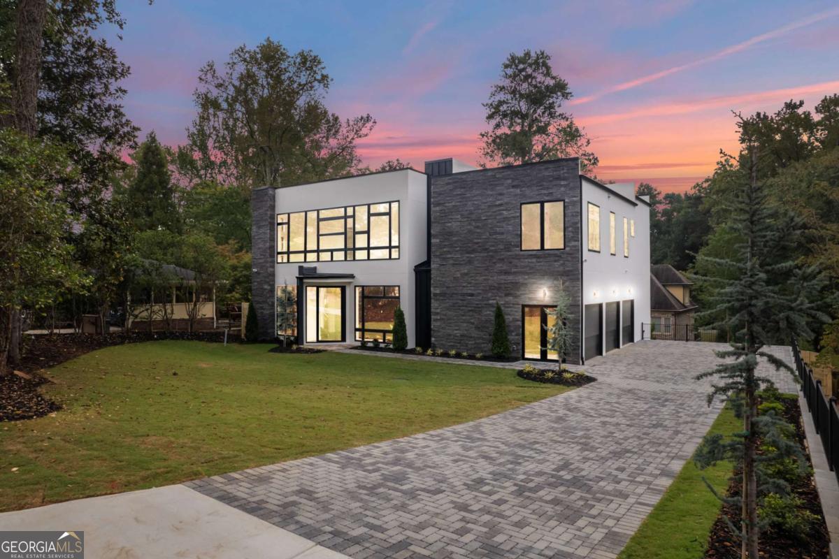 Welcome to Chastain Park in this new construction home, complete with walk out saltwater pool and spa. The stunning contemporary residence offers the epitome of luxury living. Step inside and be greeted by a grand two-story foyer, setting the stage for elegance. This home is perfect for those who appreciate space, comfort, and modern design with 12' ceilings throughout the main and second levels and 10' ceilings in the finished terrace level. The large open-concept kitchen is a true chef's delight, featuring all top-of-the-line Wolf and Subzero appliances, including a gas cooktop, double oven, refrigerator, microwave, and beverage cooler. Ample cabinetry offers plenty of storage, plus a hidden walk-in pantry can be found behind cabinet doors. High-end finishes are noted throughout the home, from the richly stained white oak hardwood floors to the soaring ceilings on all levels. Anderson windows, designed for both entertaining and relaxation, making this home an entertainer's paradise. Slide open the multi-slide doors, and you'll find yourself in an outdoor oasis. The walk-out saltwater pool and spa on the main level provide the ideal backdrop for summer gatherings and year-round relaxation. The gorgeous primary suite on the upper level offers a serene escape, with its ensuite bathroom, decked in handsome designer tiling, and oversized walk-in closet, providing a perfect private retreat. Additionally, there are 3 more generously sized bedrooms upstairs, each with an ensuite bath and walk-in closet, complete with custom built-in shelving. A large main-level bedroom also offers a secondary Primary-feel with a large closet and generously sized bathroom with double vanity and stunning tiled walls. Convenience is key, with two well-placed laundry rooms-one on the main floor and one upstairs-making everyday chores a breeze. The large finished basement is a versatile space and includes a daylight bedroom and a full bathroom, as well as an expansive entertainment area for family gatherings or hosting guests. Just minutes from all that Sandy Springs and Buckhead have to offer.